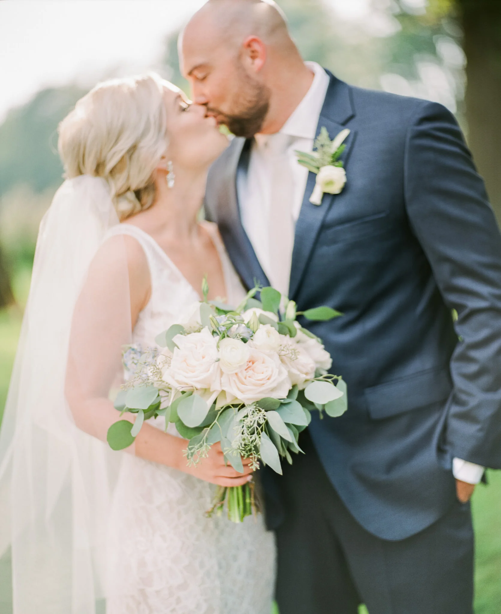 Image of bride and groom kissing with bouquet taken with Pentax 67 using the Schneider Cinelux Ultra MC 120mm f/2 lens