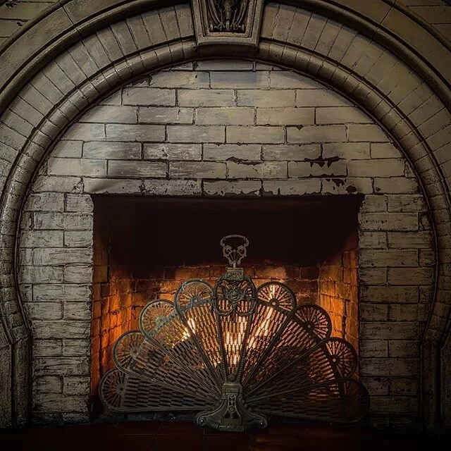 This beautiful fireplace haunts the lobby of the #crescenthotel in Eureka Springs. Cozy!!! #fireplace #oldfireplace #antiqueaesthetic #oldbrick #haunted