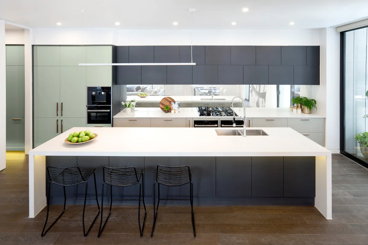 Contempo Twist - Andy & Ben from The Block have created a modern kitchen with an Art Deco twist fitting the heritage of the building. Colour and texture have been used in interesting and refreshing ways to celebrate Art Deco whilst keeping clean contemporary lines. Top cabinets in Black Riven have been offset to create interest and play on the Deco style and have been paired with Newbury Baye and Bayleaf creating a fresh colour palette. An entertainer’s dream, the design features ample storage throughout both the kitchen and sizable butler’s pantry, chic NEFF appliances and stunning Caesarstone ® Fresh Concrete benchtops.