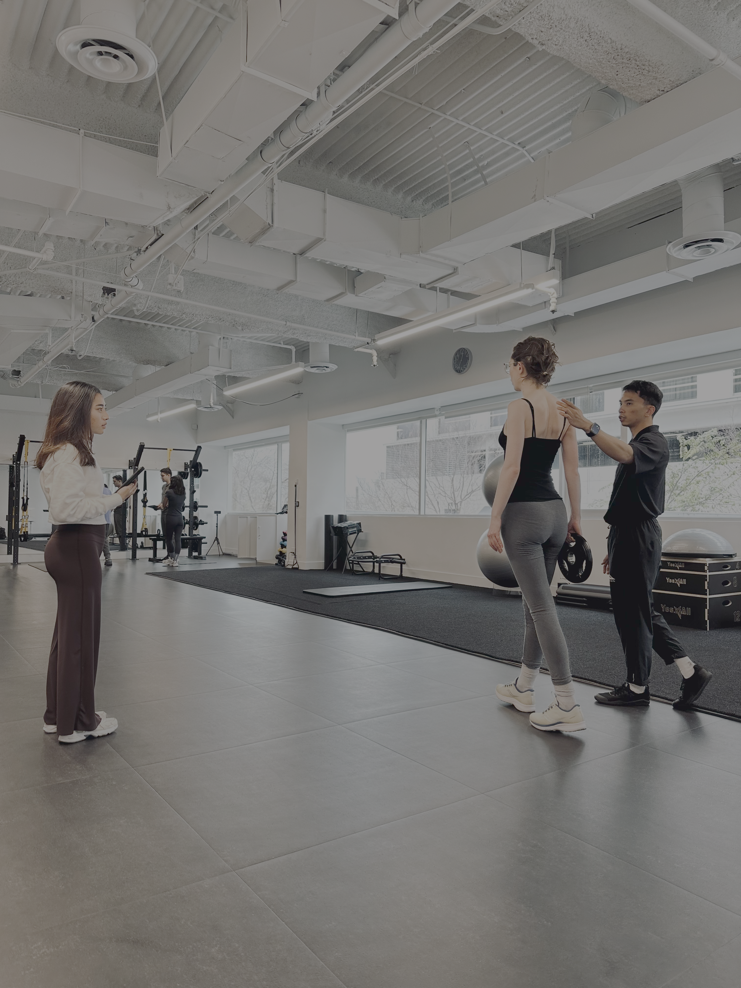 physical therapist helping patient with low back pain to walk properly