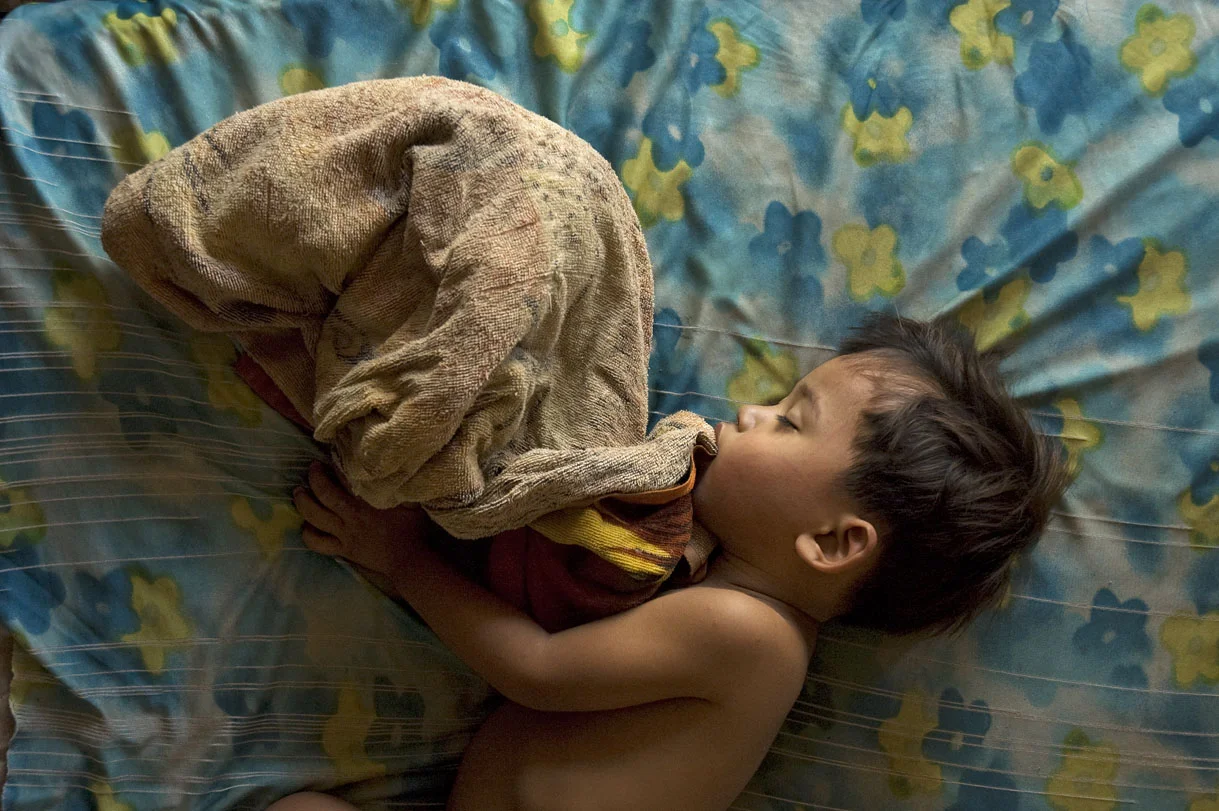 Sinat sleeping at home in Phnom Penh.