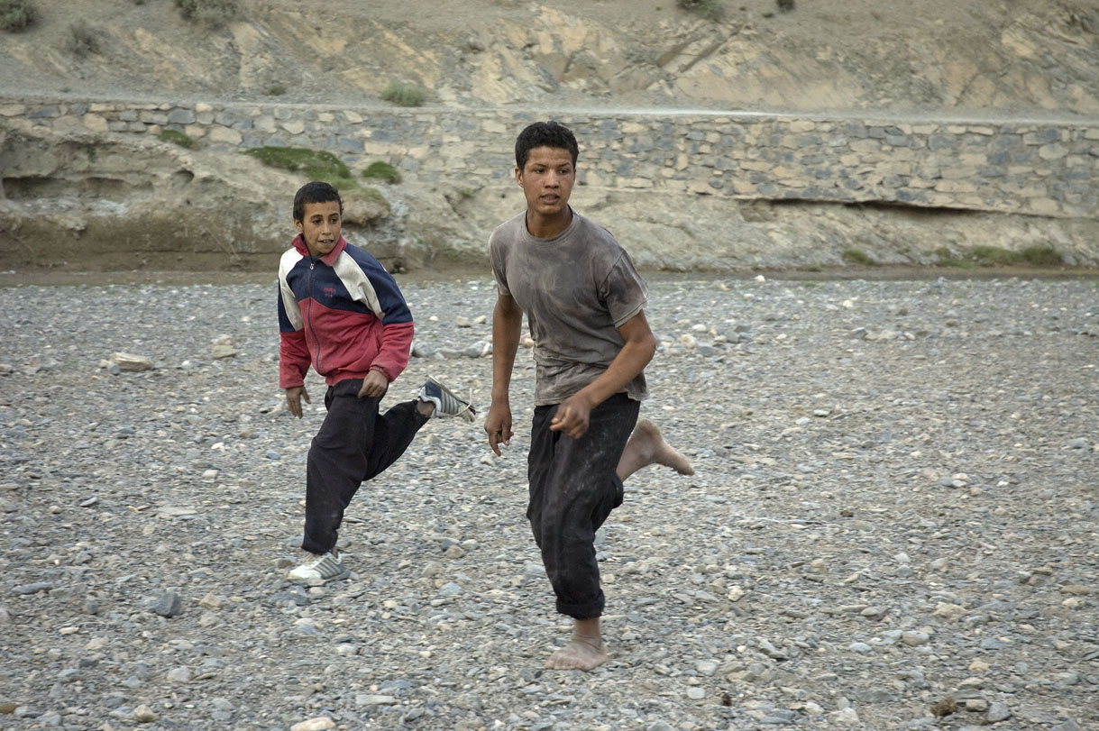 Playing soccer on the dry river bed.