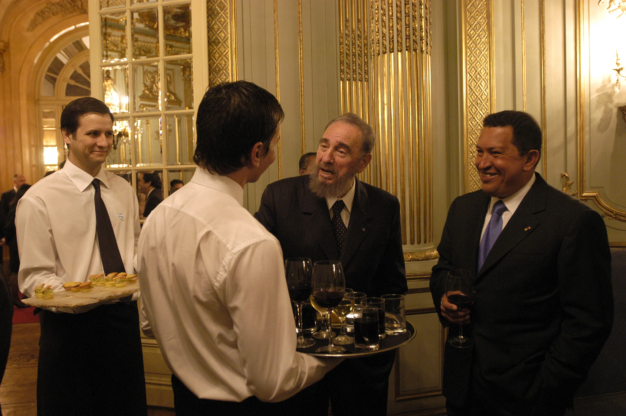Fidel Castro and Hugo Chavez at a cocktail in Buenos Aires, 2003.