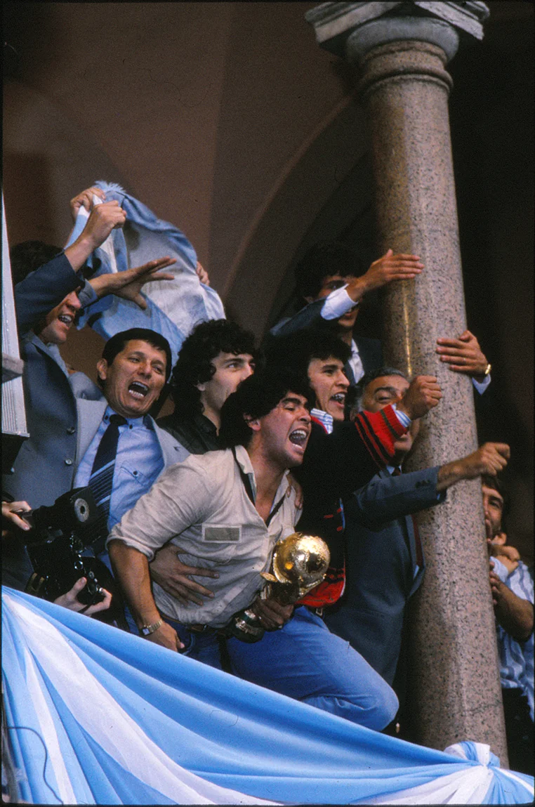 Maradona with the 1986 soccer world cup in the Presidential Palace balcony, Buenos Aires.