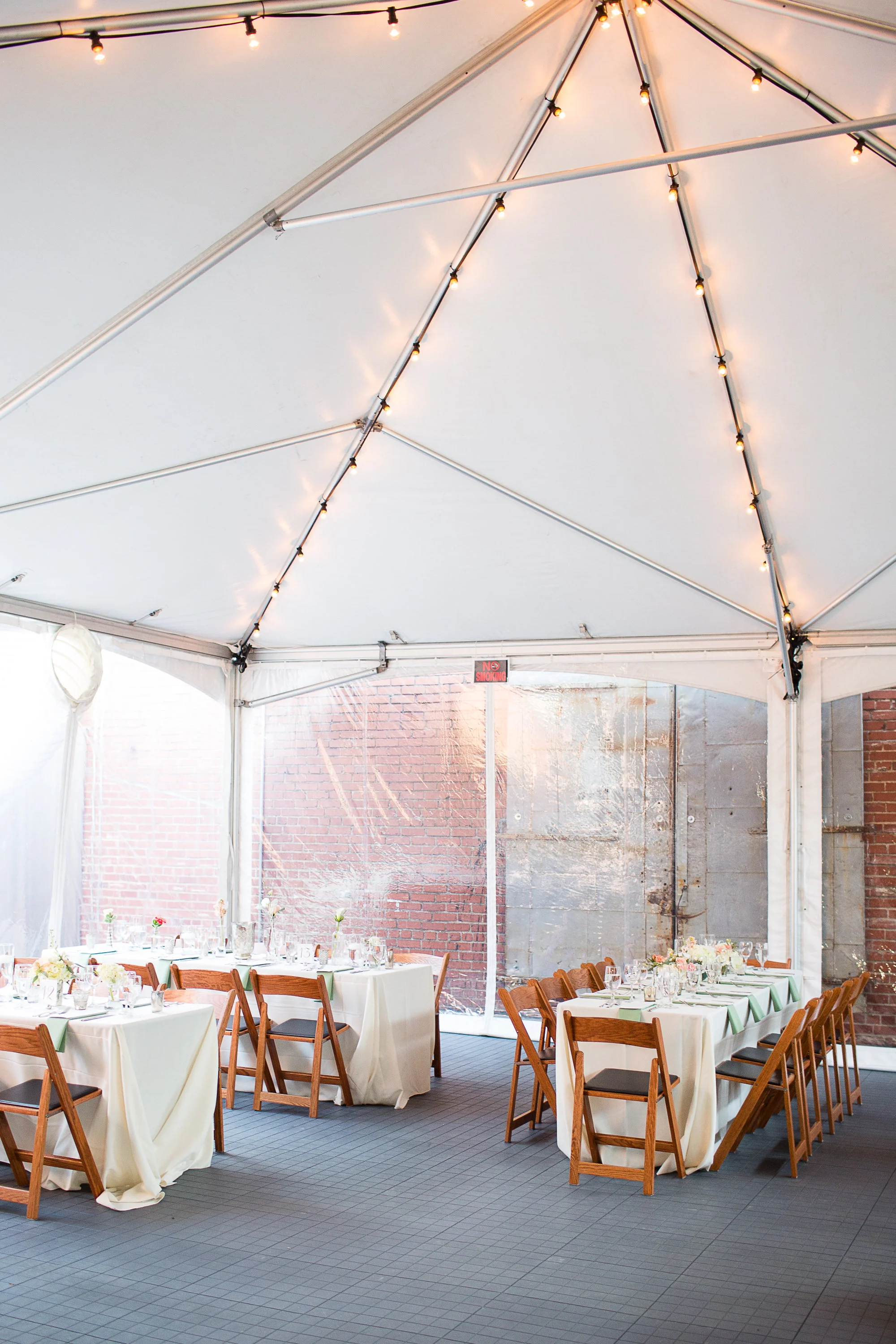 Tent with market lights and walls to contain heating and cooling. Flooring also shown here.