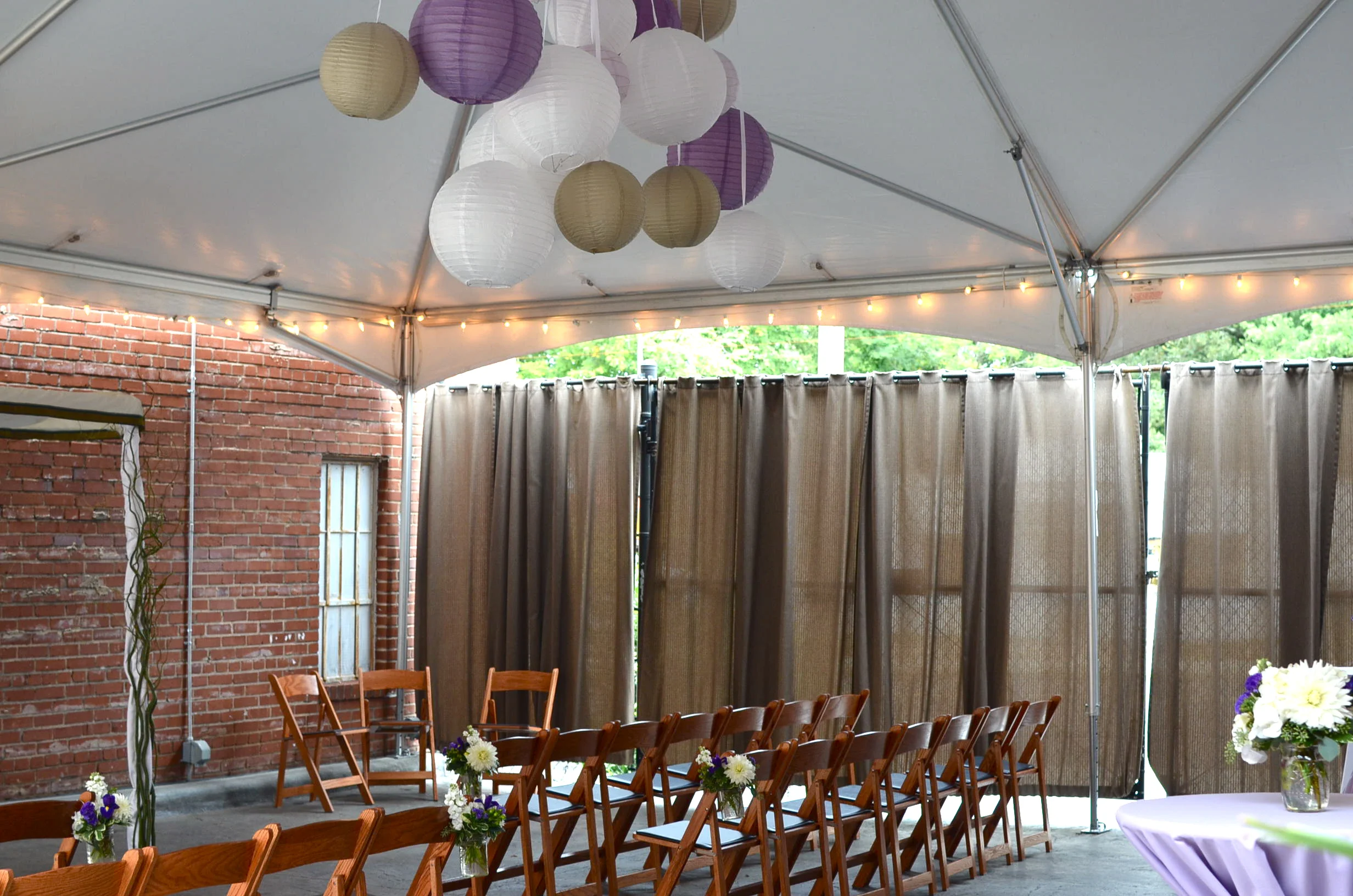 Open-air tent with paper lantern chandelier from Tre Bella