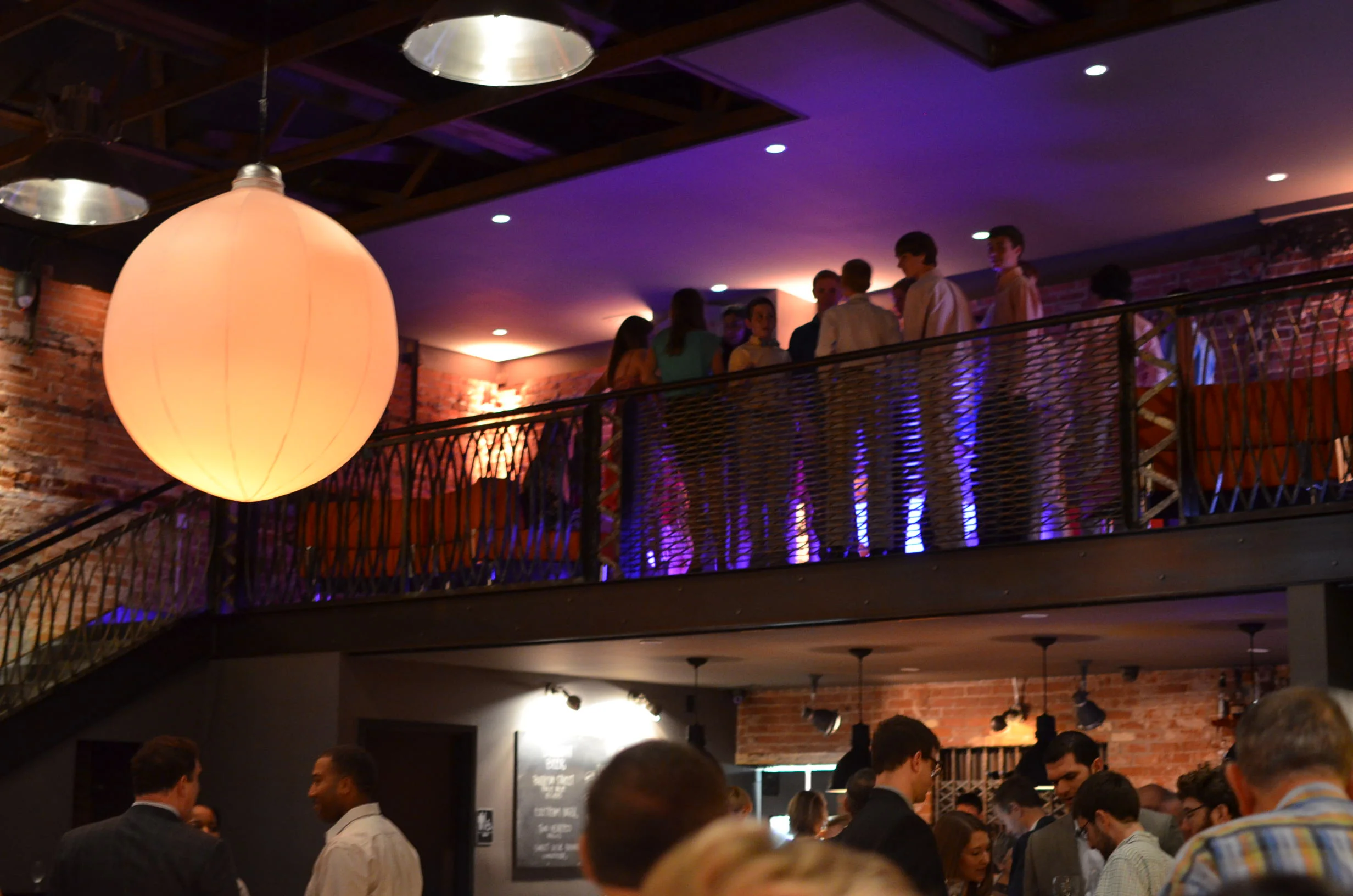 Guests overlook the Front Room from the mezzanine