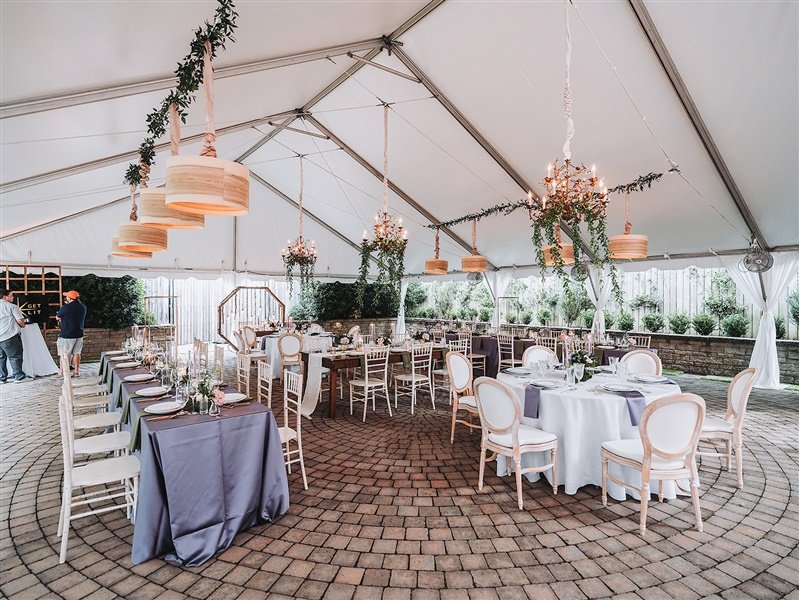  Outdoor tented reception space tented with linened tables  