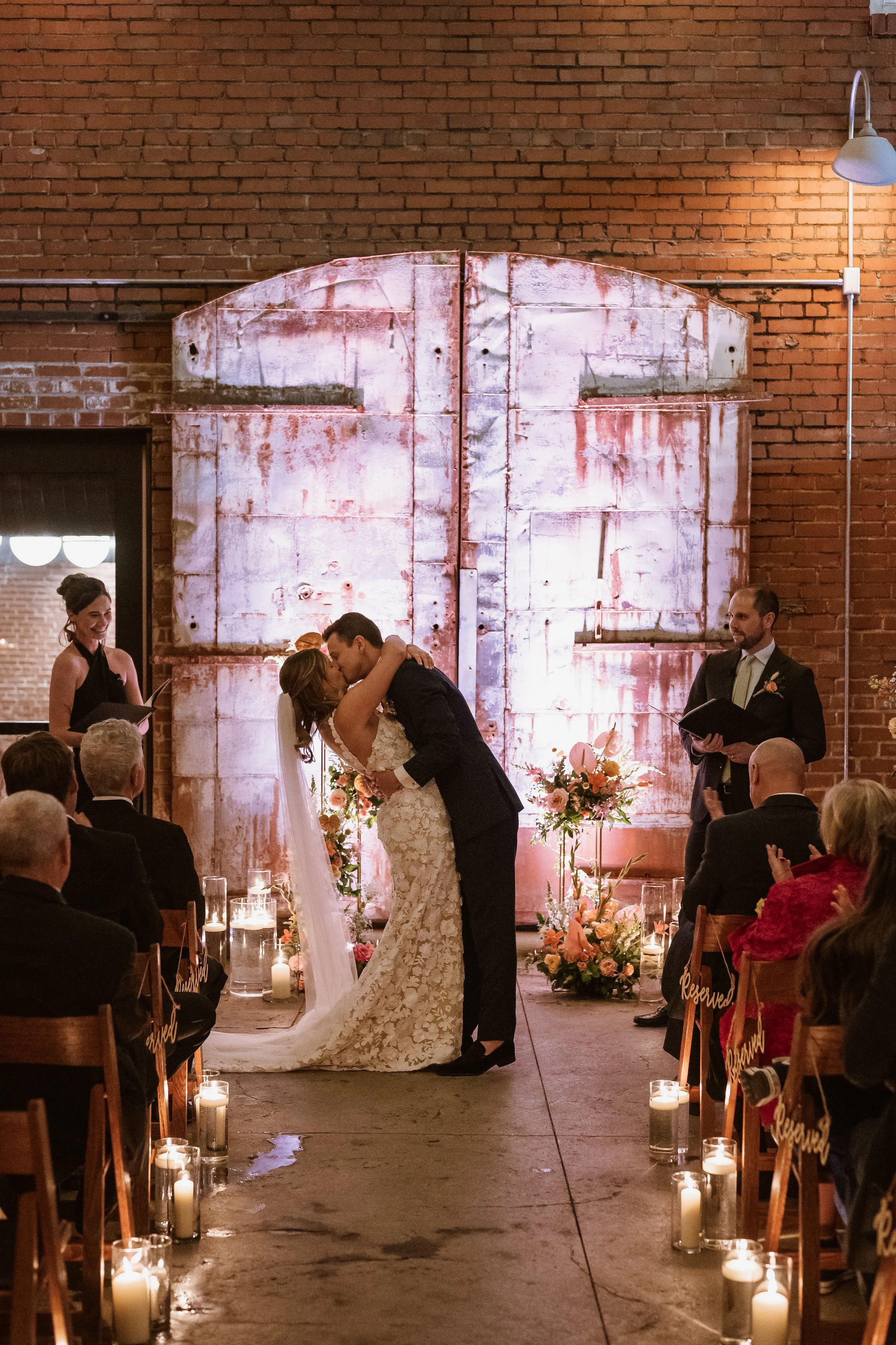 Bride and groom kissing in outdoor wedding ceremony