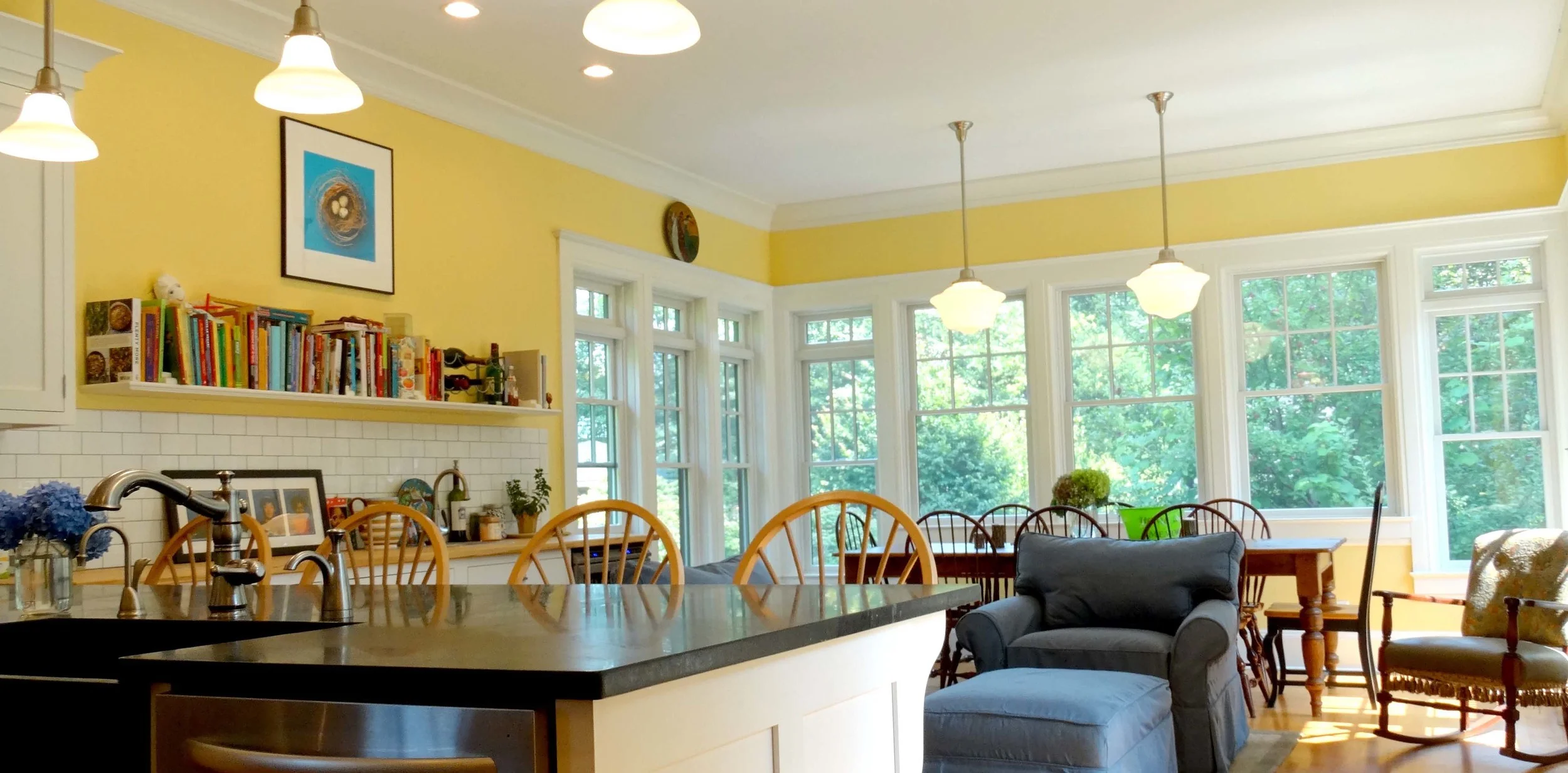 Building out from the shorter footprint, we were able to accommodate ample kitchen work space, casual dining at the countertop, conversational family space by an added fireplace and a window-flanked dining area which comfortably seats eight for relaxed intimate dining. 