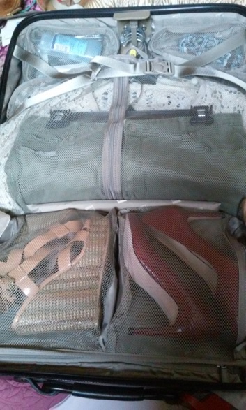 Suitcase dividers folded over to roll the stacked clothes.
