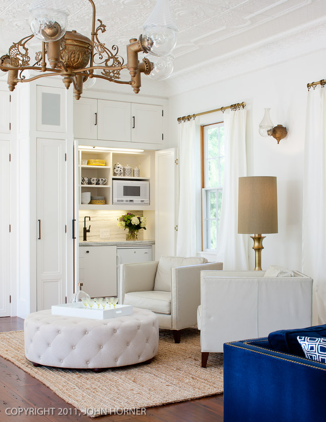 Original converted gaslight fixture with matching sconce and kitchenette, hidden behind bi-fold doors.