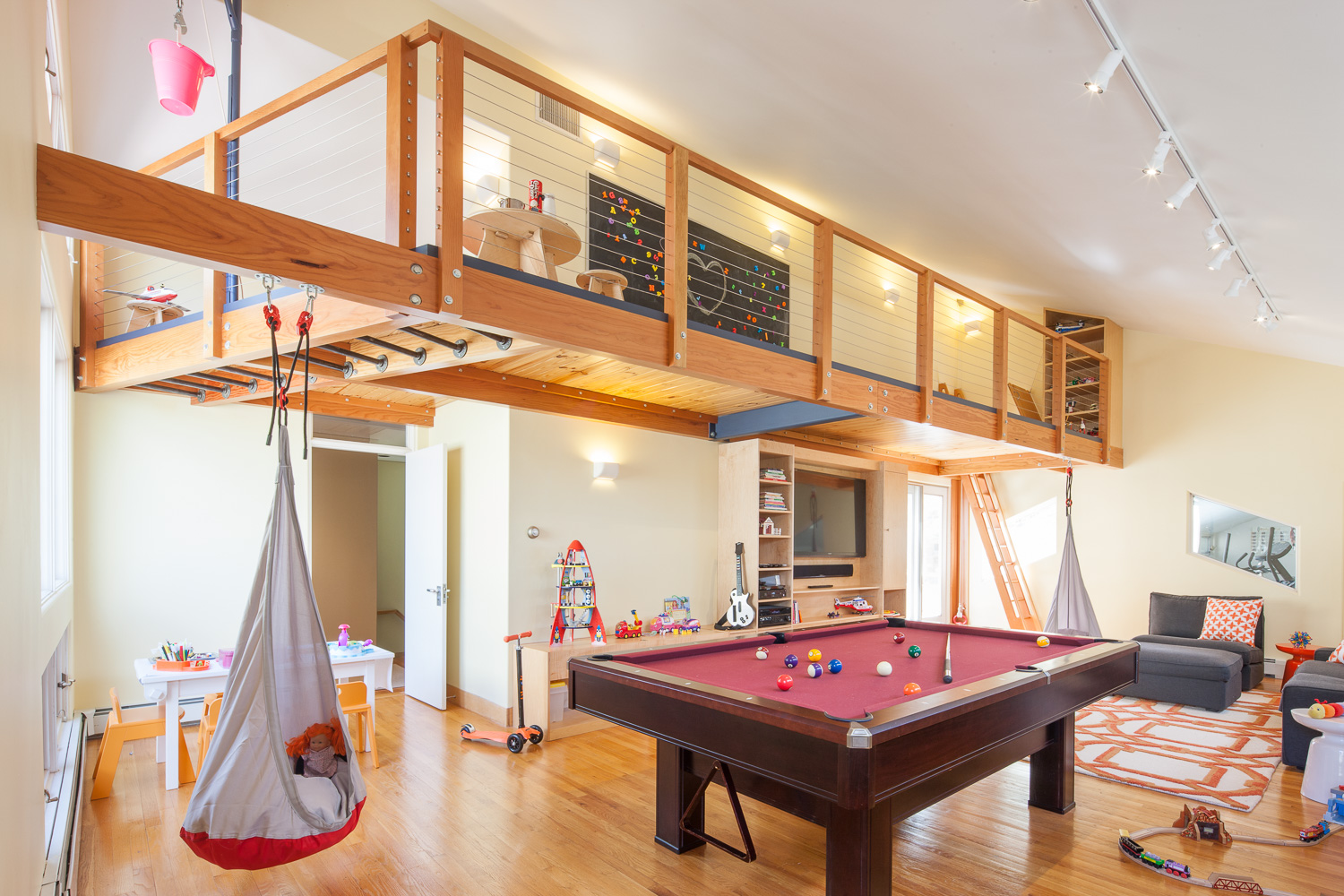  Cantilevered kids’ playroom loft with trap-door ladder access, monkey bars, and well wheel. 