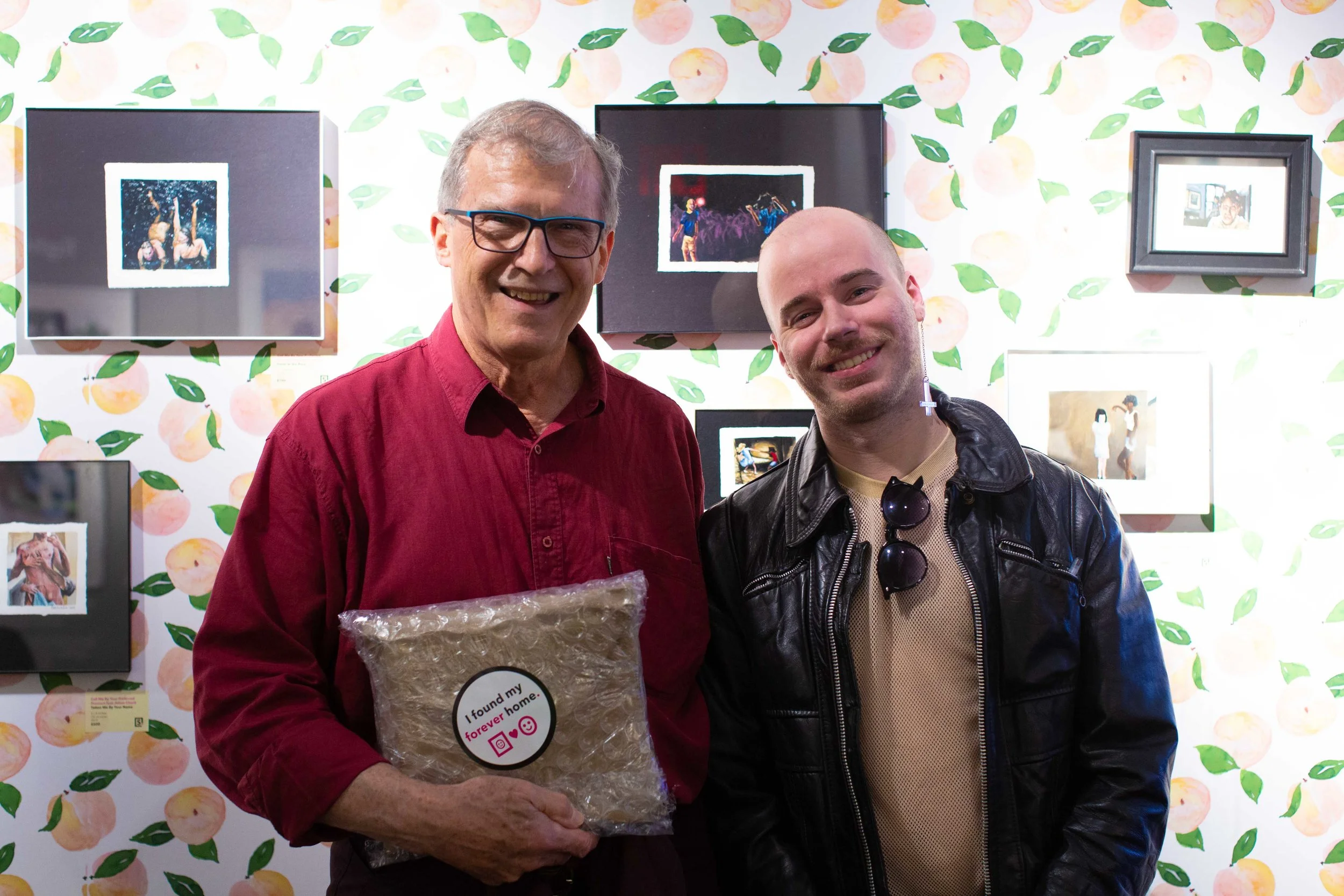 Above: Adam Chuck poses with a new collector in front of his “Call Me By Your Preferred Pronoun” installation at Superfine! Art Fair in NYC, May 2019.