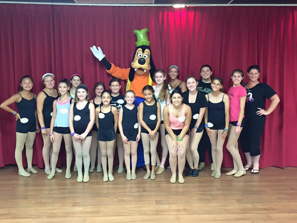 positions dance studio performance group members, miss rebecca, & goofy!