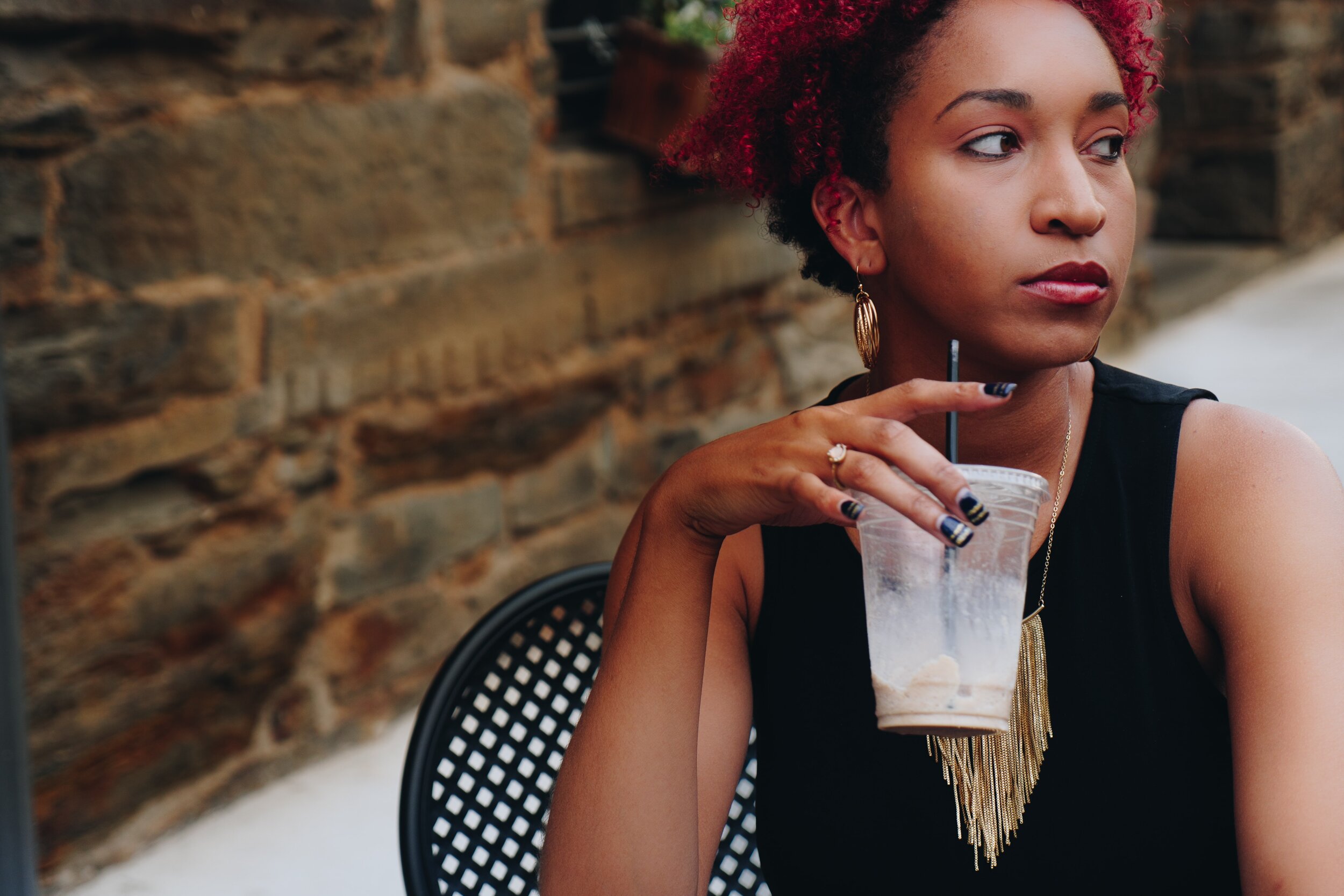 woman looking away with drink in her hand 