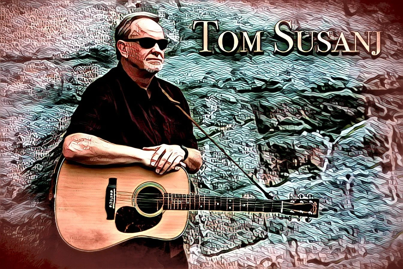 tom susanj standing against a wall with an artistic filter, with his guitar with the words TOM SUSANJ in the top right corner