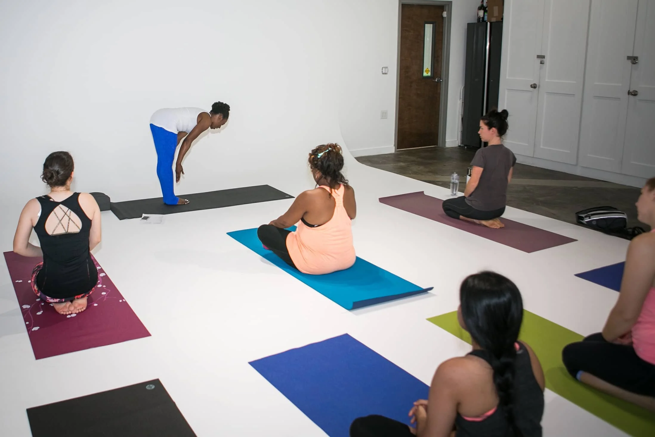 Ivory Howard demonstrates yoga pose to a power yoga class.