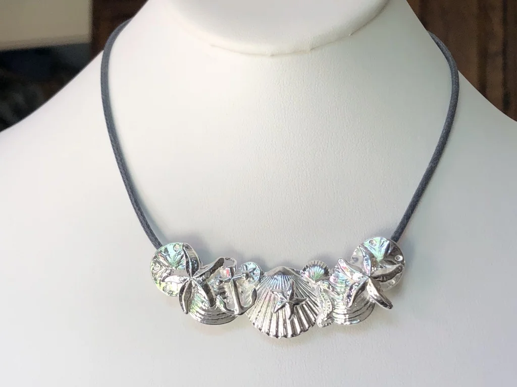 large seashell collage on grey cord.jpg
