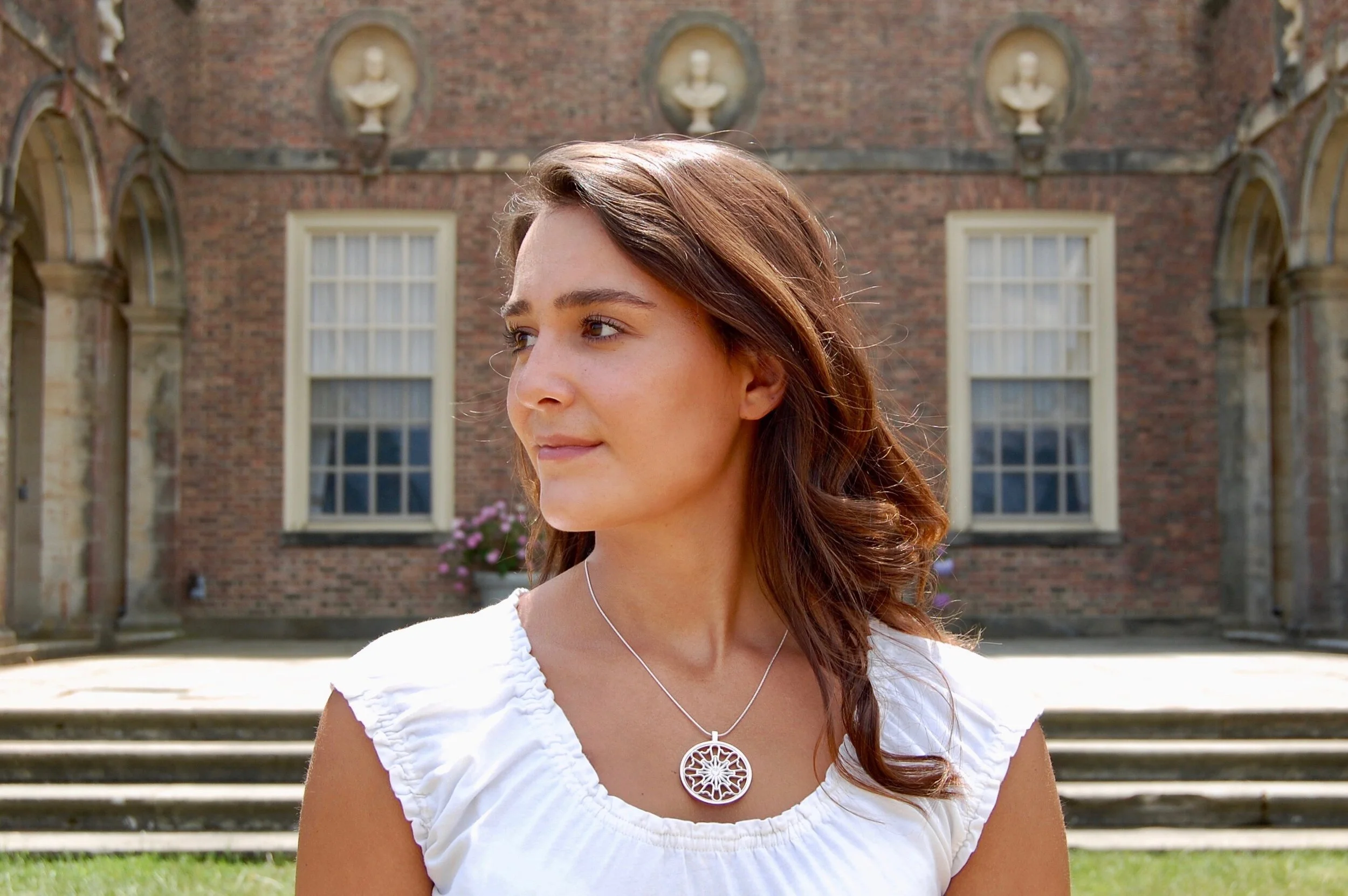 Becky modeling sunburst medallion with stone.jpeg