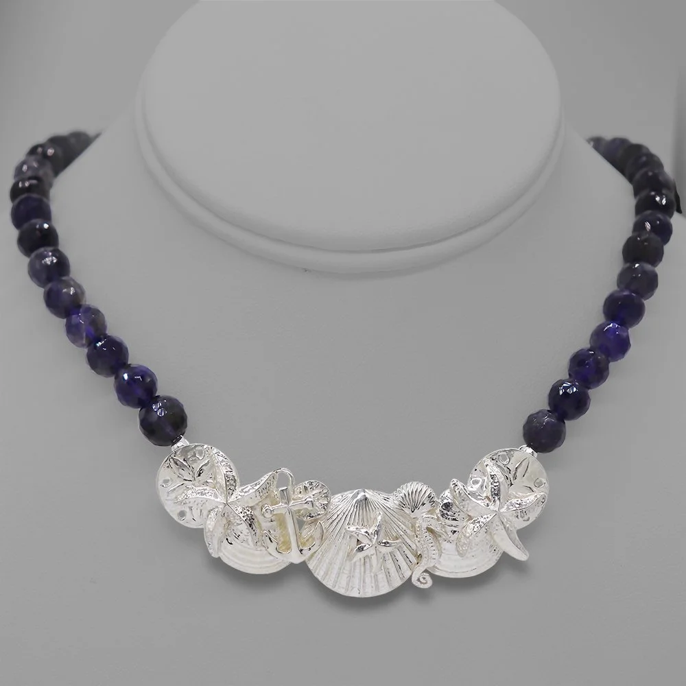 SEASHELL COLLAGE ON IOLITE.jpg