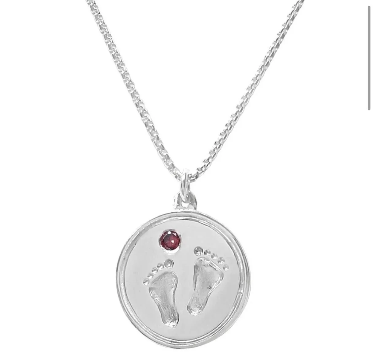 Garnet, a deep red stone serves as the January birthstone symbolizing protection, love, and vitality. Seeking a January birthday gift? For the new mom choose the Baby Feet pendant or for the cardinal lovers choose pendant or earrings adorned with dee