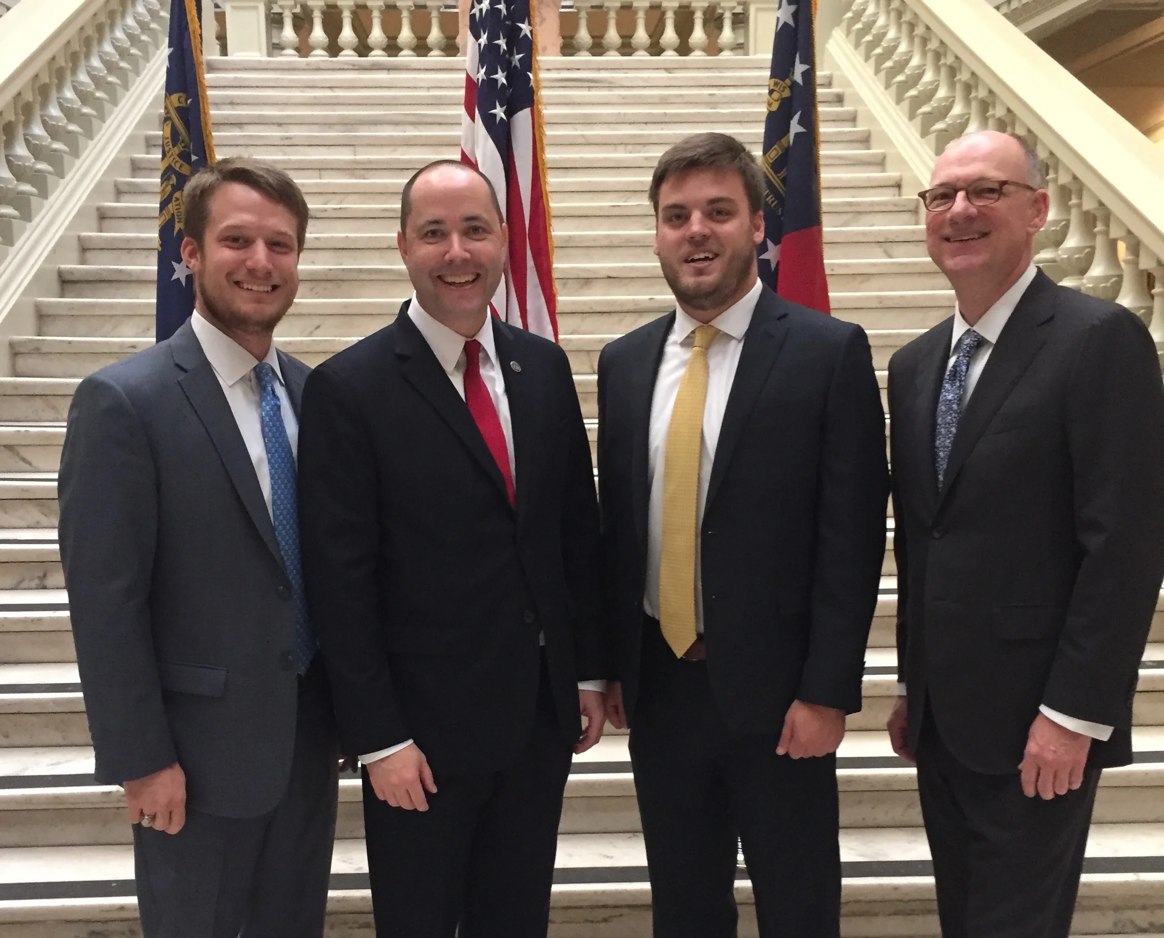 The Jl morgan company team stands with georgia attorney general chris carr at his swearing in ceremony on november 1, 2016.