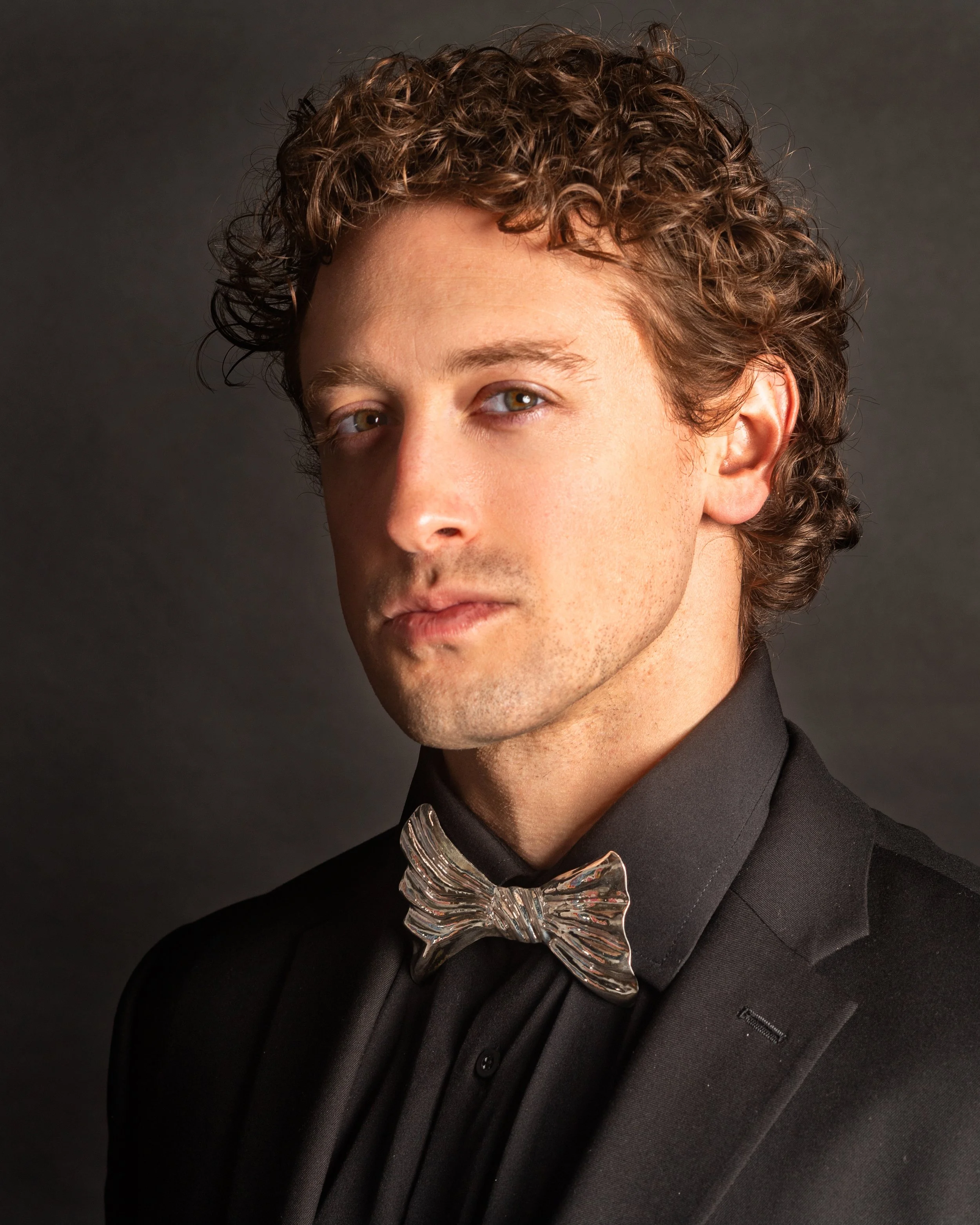 white man wearing sterling silver bow tie in black tux by Freddie Collier studio