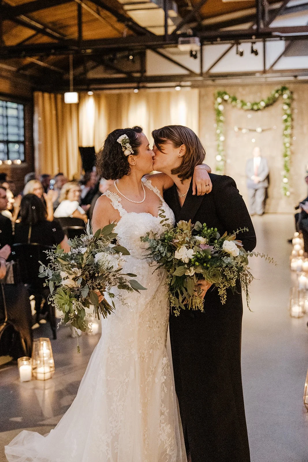 two brides kiss after their ceremony