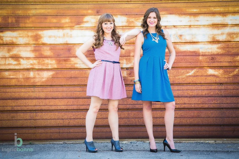 two women business owner wedding planners in front of a garage door
