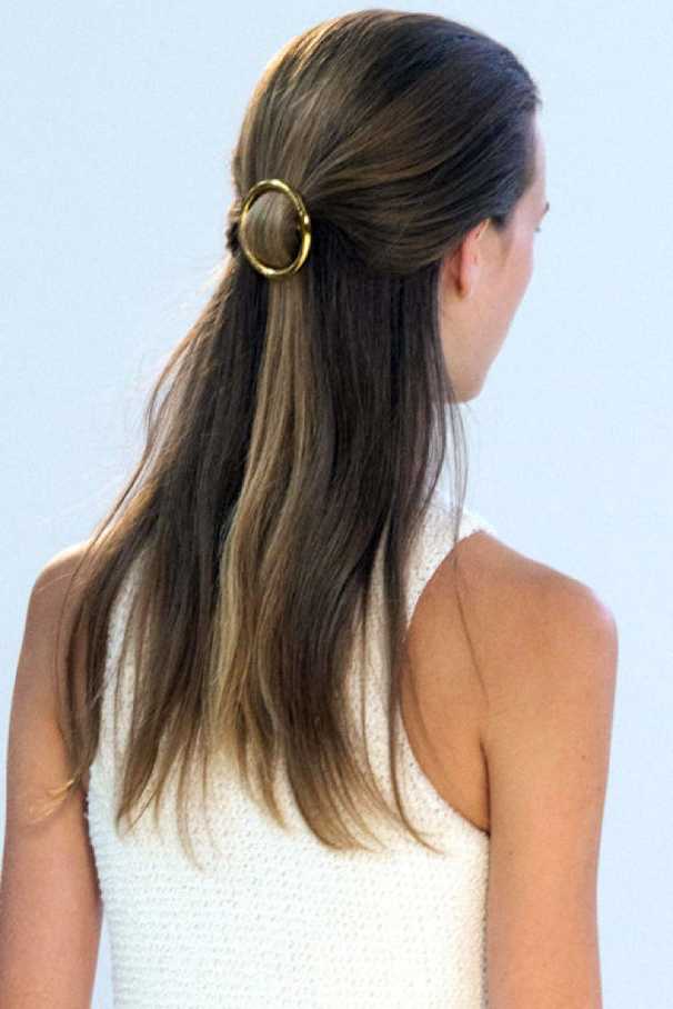 Blow-dry your hair with a large round brush, once dry lightly spray with some dry shampoo/ texturising spray. Section the hair from the tops of the ears up towards the crown and gather loosely as if you are doing a ponytail and secure with your clip.. Don't stress, you may need a couple of try's to get this perfect!! Once in place, smooth any fly aways with a light mist of hairspray.
