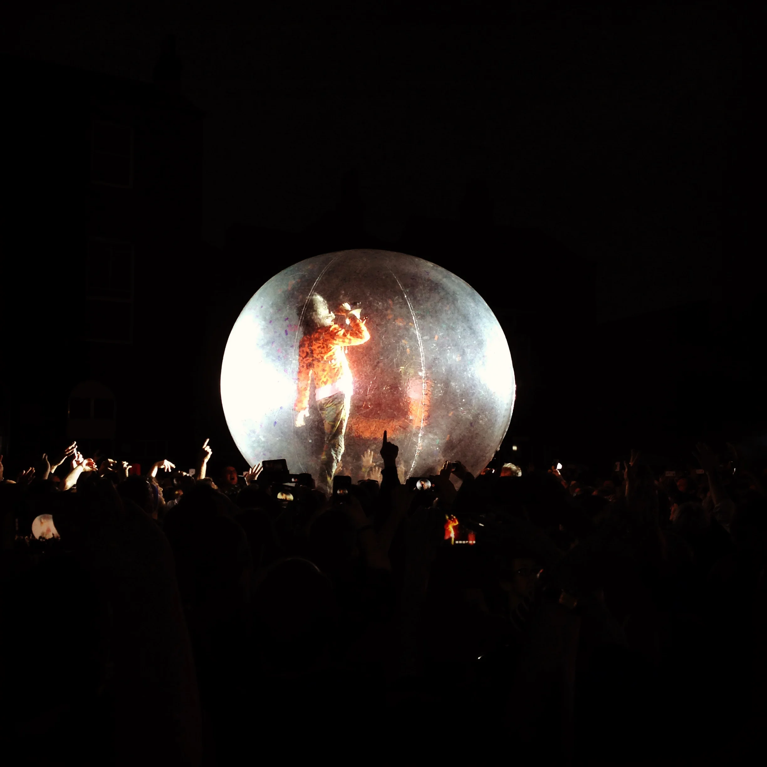 "For here I am sitting in a tin can" - channeling Bowie in a giant ball on top of the crowd.