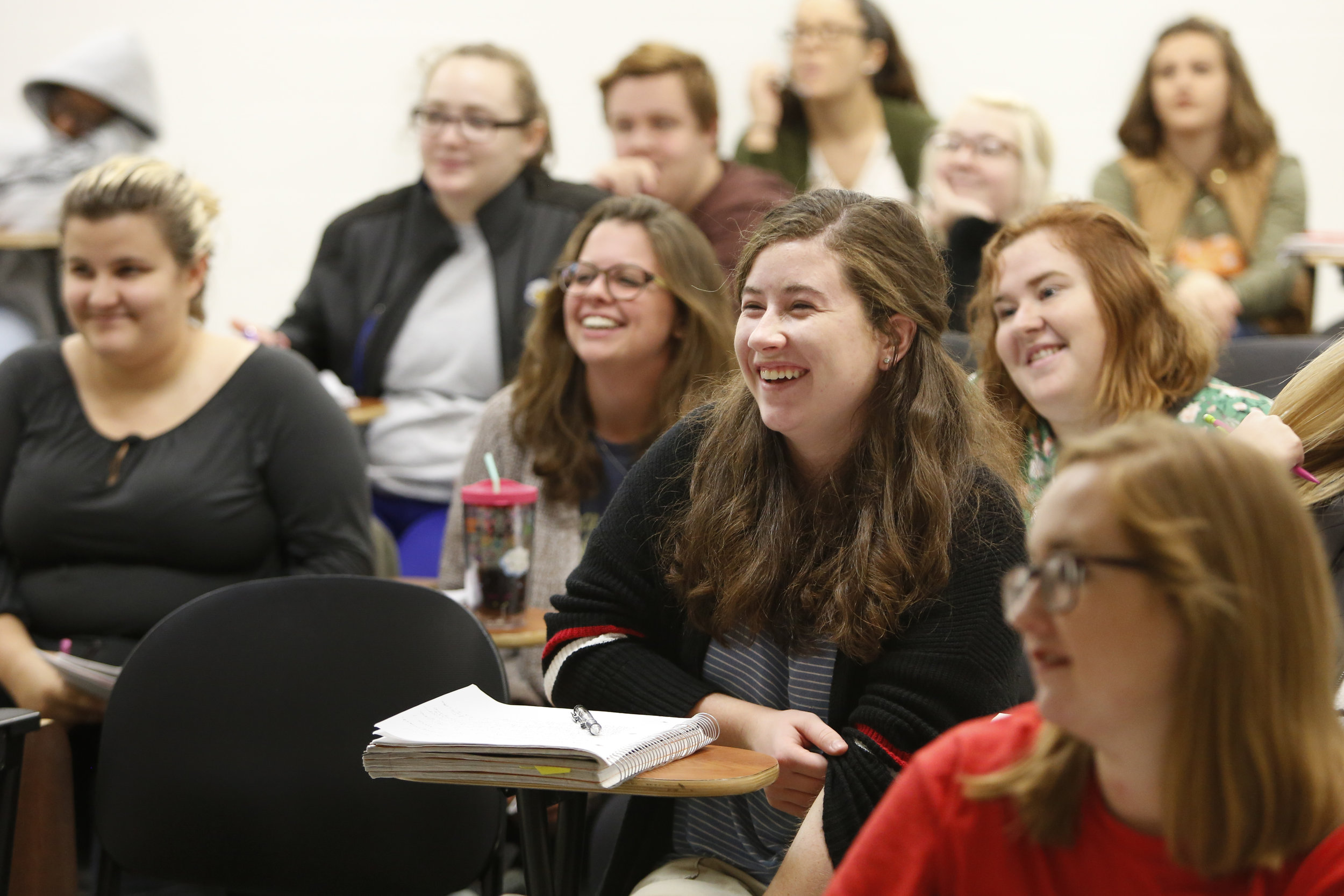  Grace and her classmates laugh at a professor’s quip during government class. &nbsp; 