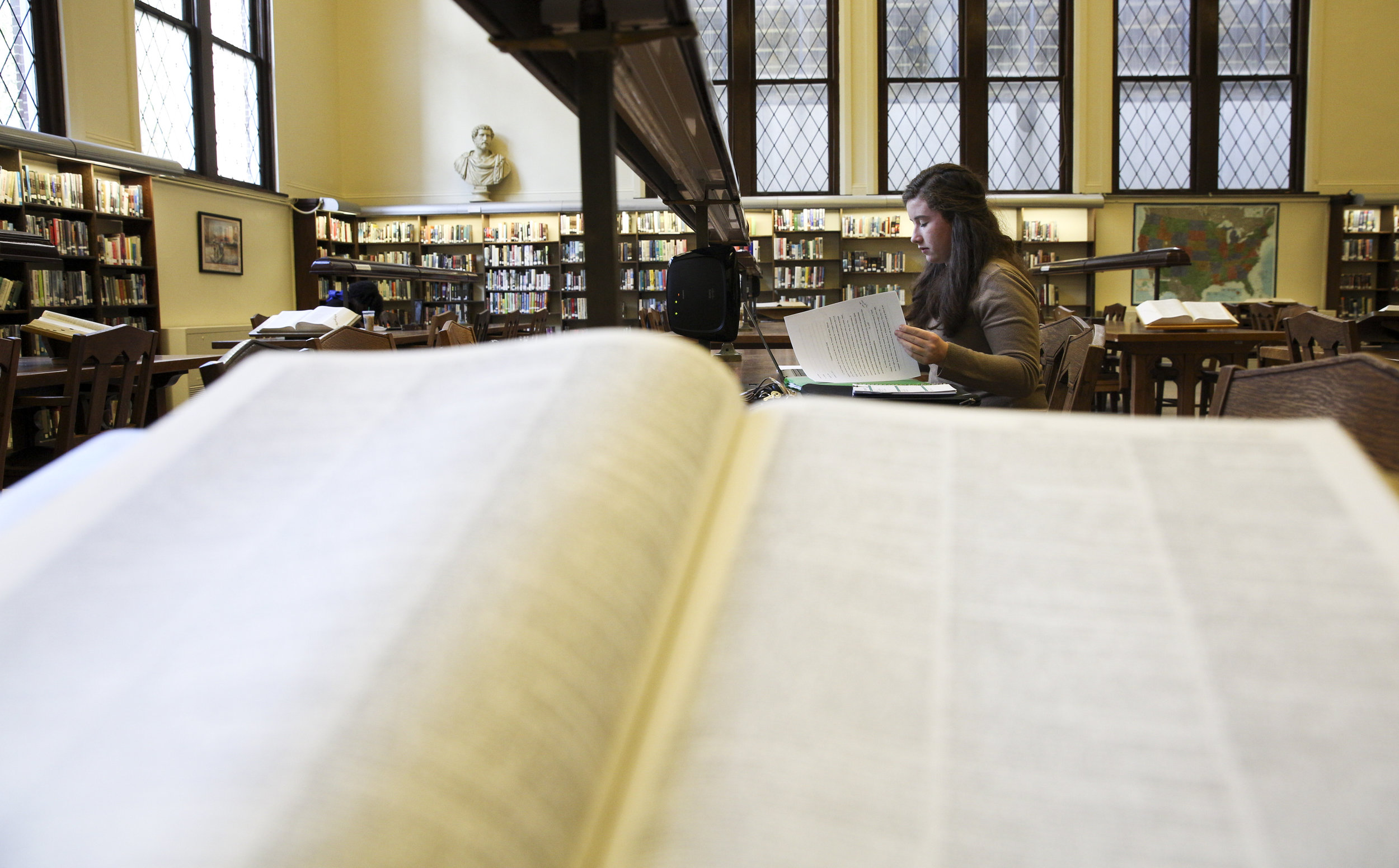  Grace works on an English paper at her favorite spot in the library. “It’s real pretty. It’s really old school…all of the chairs creak.” 