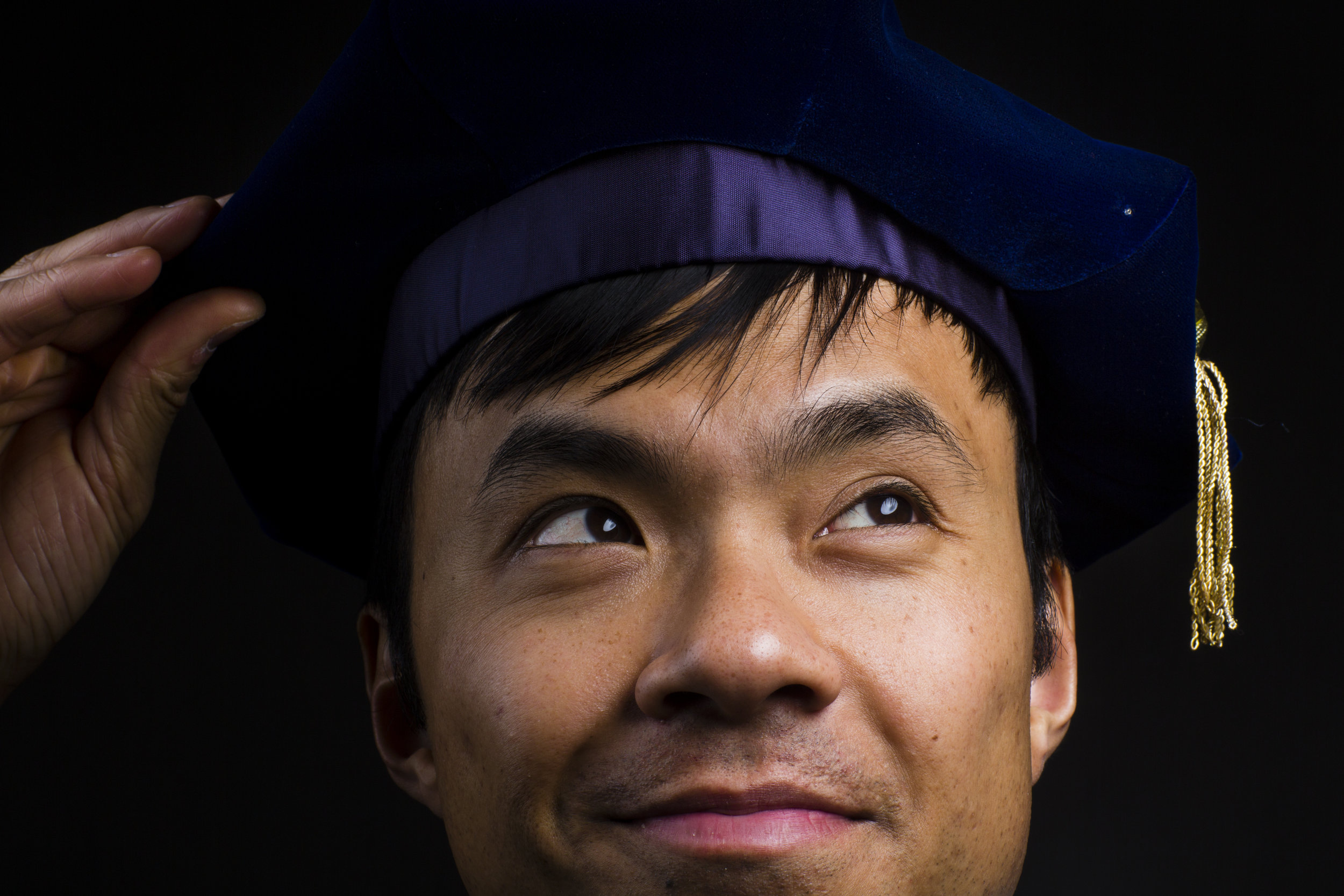  Assistant Professor of Sociology Freeden Blume Oeur, who earned his PhD from the University of California, Berkeley here wears the regalia that his parents, immigrants from Cambodia, purchased for him as a graduation gift. “I couldn’t afford to buy 