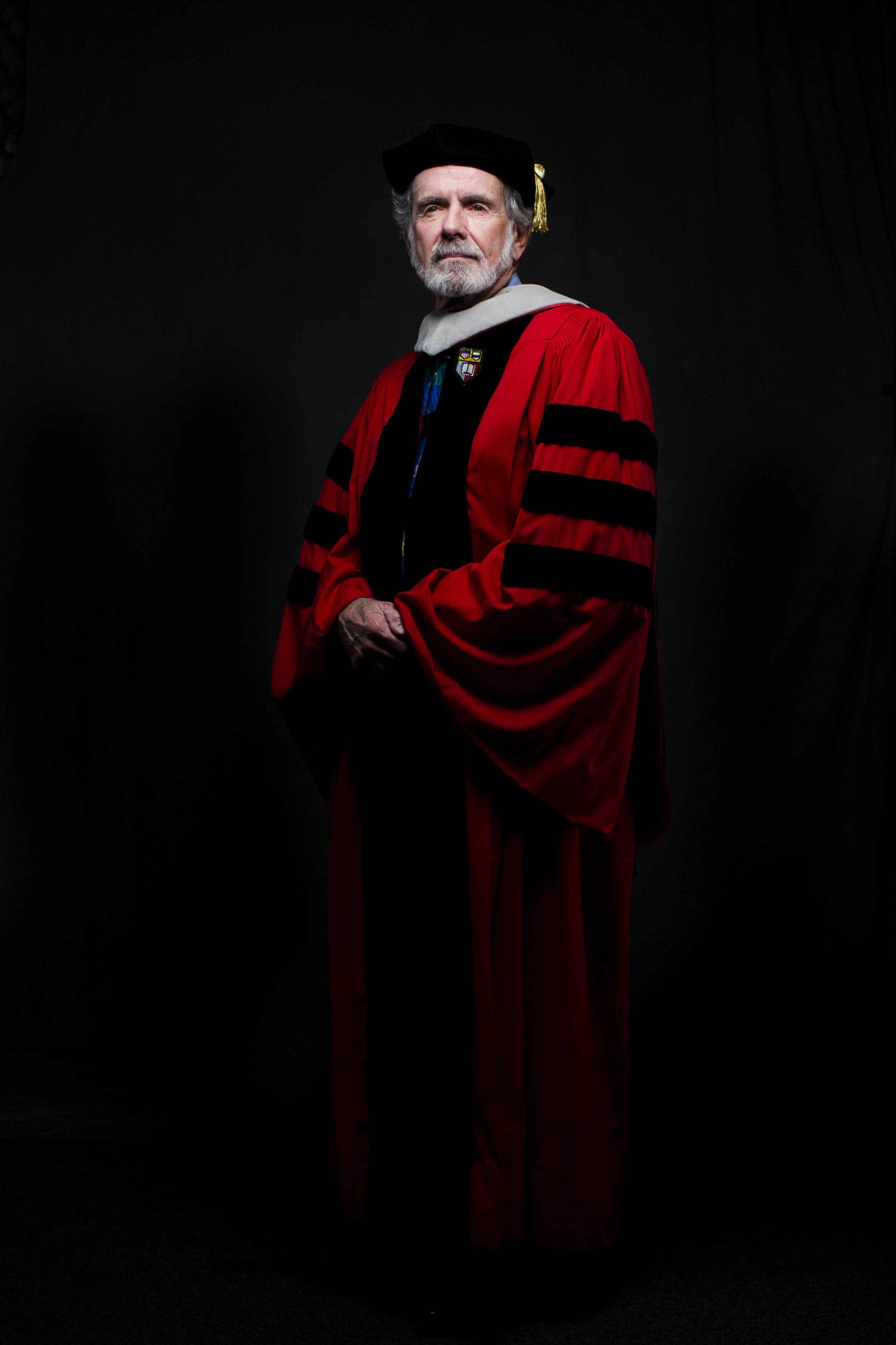  Professor Emeritus Anthony “Tony” Schwartz is photographed wearing a gray hood and carnelian red robes from Cornell University, where he received his veterinary degree. Schwartz, who served as a professor of surgery and associate dean at Cummings Sc