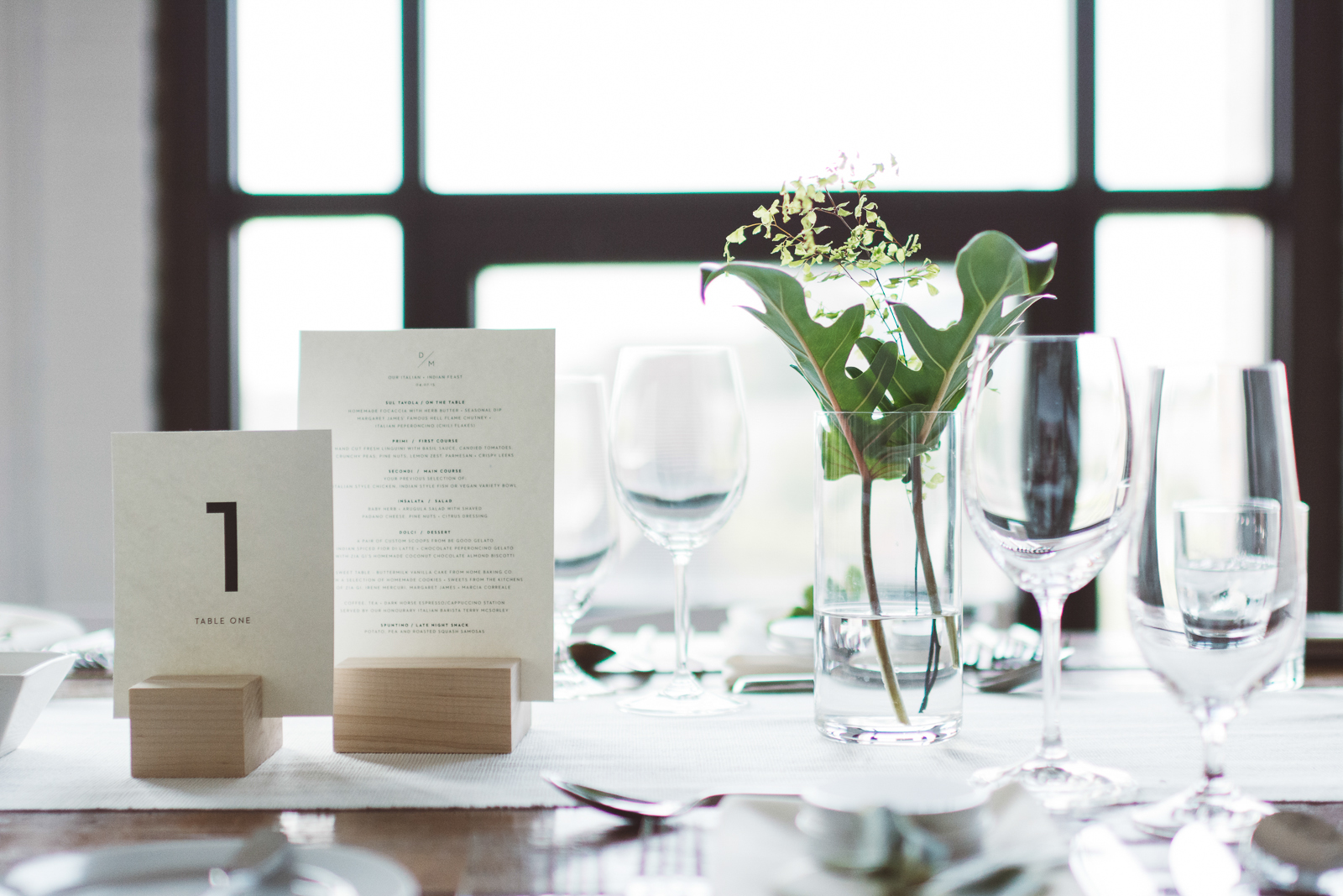 Table details, including menu and table number cards in custom designed maple holders by woodworker Giorgio Antonacci.