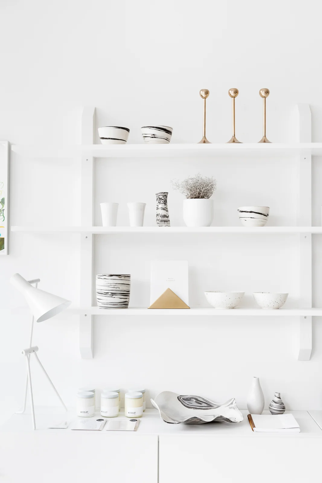 A detail of the 14 foot custom designed wall unit, built by woodworker Giorgio Antonacci, which acts as a subtle and ever changing display for products.