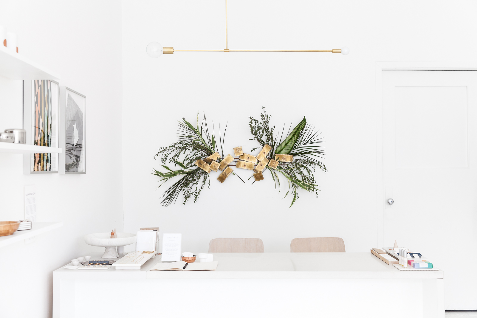 A custom designed cash desk with quartz top doubles as a work desk. Lighting by Montreal design studio Lambert et Fils.