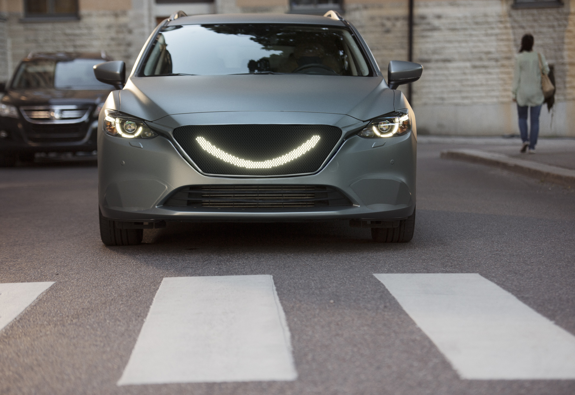 07 - When the self-driving car’s sensors detect a pedestrian a smile lights up at the front of the car and the car stops.jpg