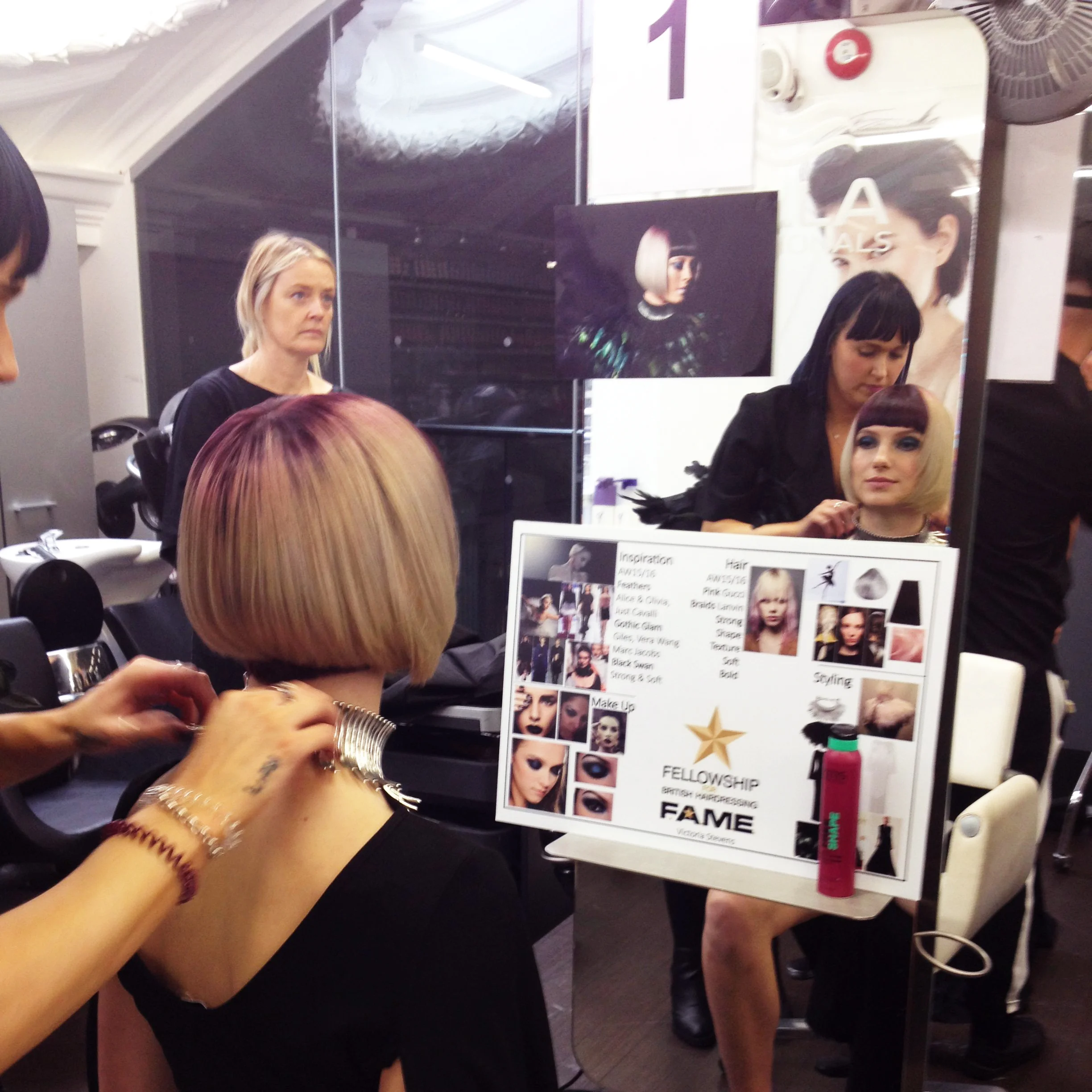 Vic adding the finishing touch to the model's outfit.