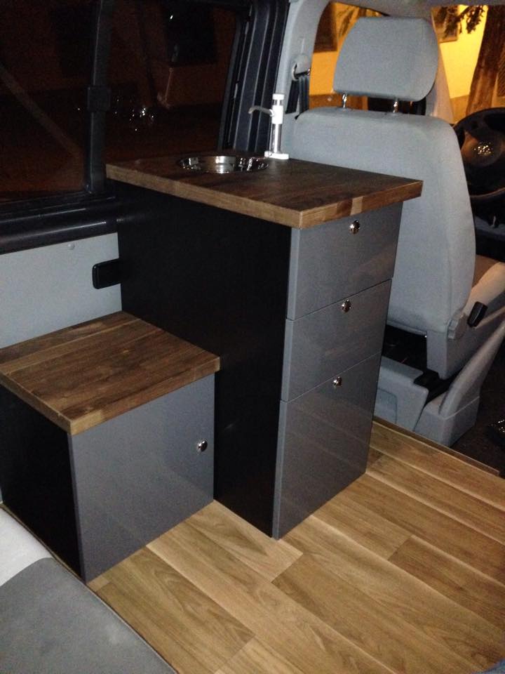 Office cabinets modified to fit inside the van, and a DIY sink