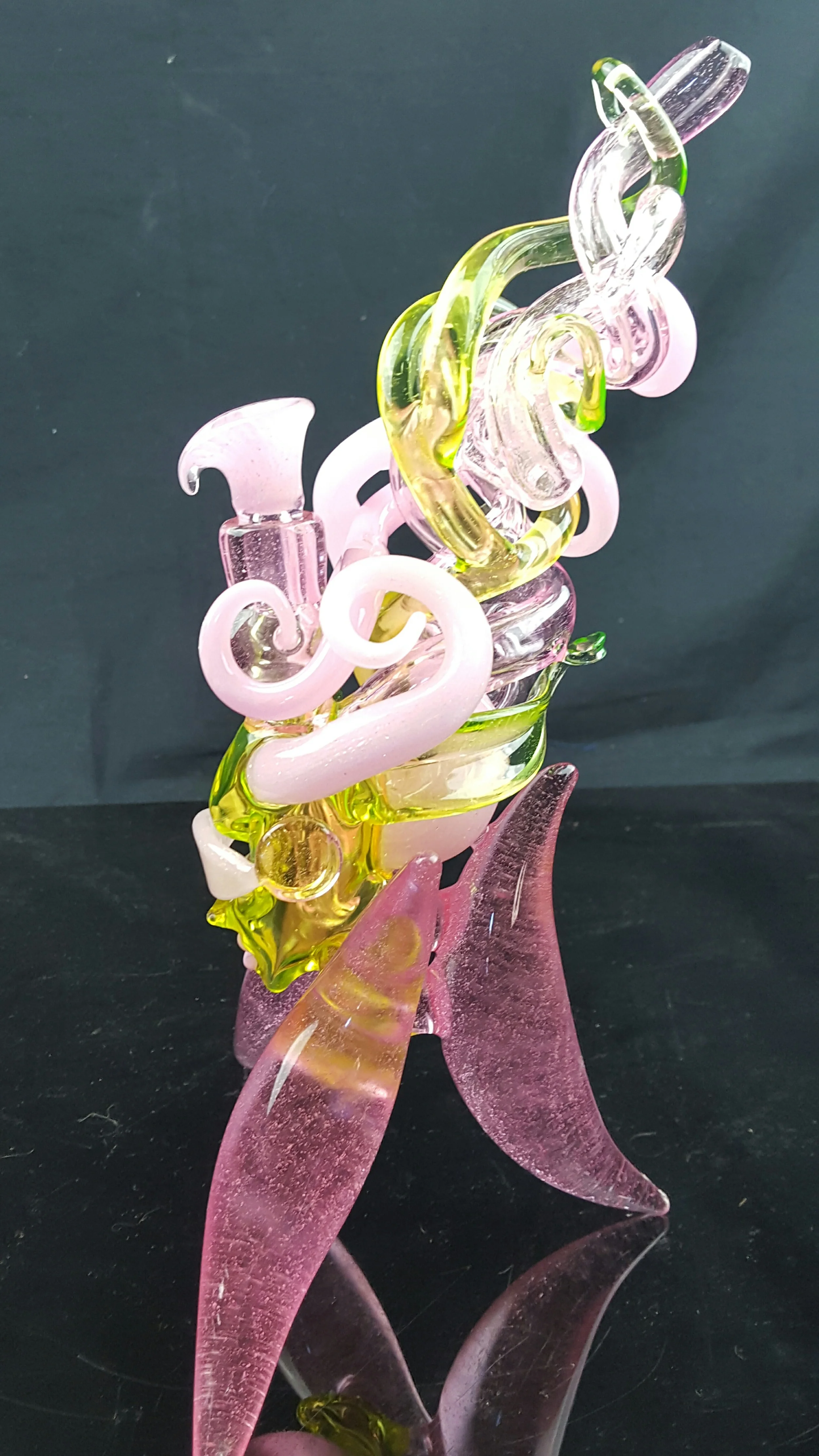 For almost 10 years my muse has been the female form, with a special affinity for the movement of hair. Early on, I found that the flowing nature of glass mimicked the natural flowing nature of a woman's hair. I've been drawn to this idea with near obsession for years. To me the beauty of glass lies in the curves and the flow of its lines. No other medium on earth can accomplish these ideas so delicately and perfectly. Addicted to this idea, I repeated my self over and over again, unsure over the years of what I would discover... Until now. Years of trial and error have finally brought the epitome of form and function to my work. Previously I had gone about the same formula, and my work became stagnant for it. This year I threw out my old patterns and replaced them with fresh ideas. Finally the "princess series" with this "hair tech" idea has come to fruition. Finally, the princess has learned all the vocabulary necessary to speak your language. Now she's got all her tricks and tools, she's fearless, ready to scream at the top of her lungs....Are you ready to listen?