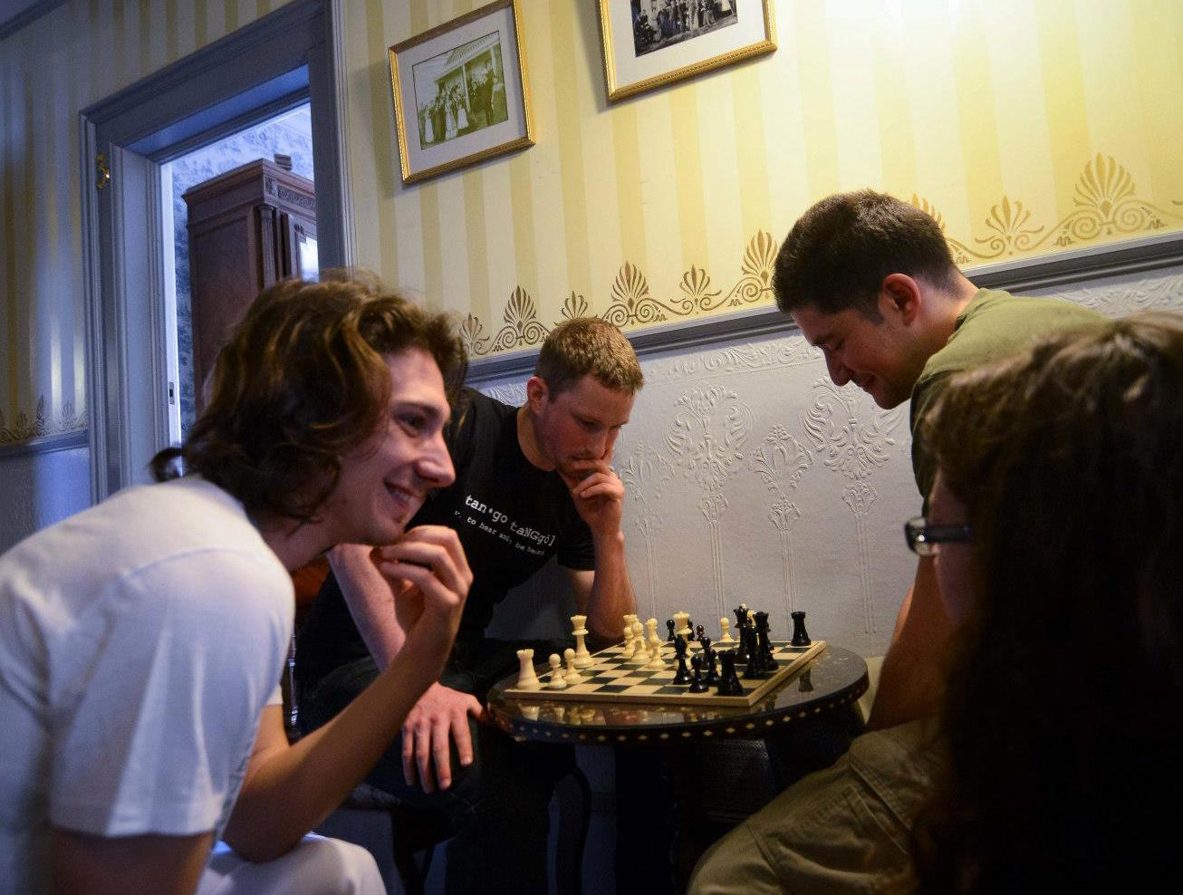 Dancer-organizers playing chess at Weller House Inn at the Tango Slumber Party in 2013. Photo by SubbusClicks . 