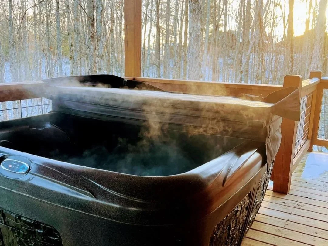 steaming hot tub at Laurel Fork Rustic Retreat during winter
