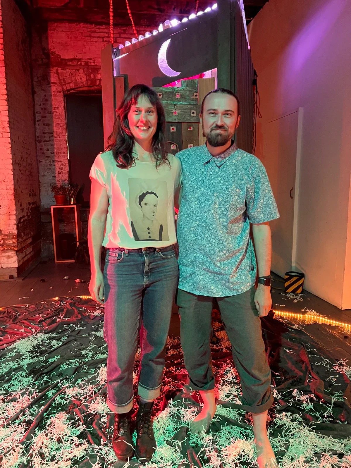 Nina Fry and Jon Robertson standing together in front of the installation