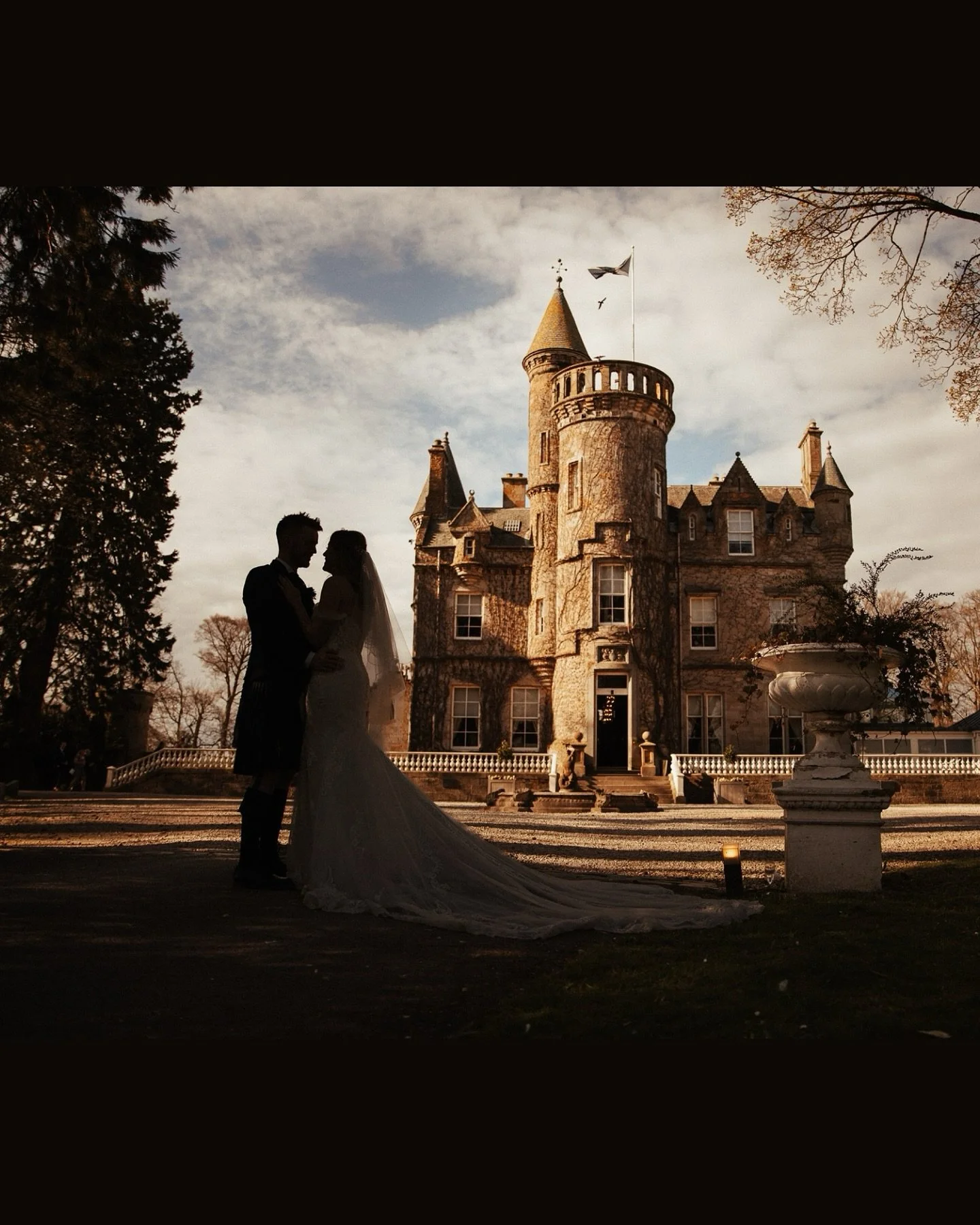 🍃 Beneath the towers of a fairytale castle, they stood hand in hand, wrapped in golden light and quiet excitement. Her dress flowed like a dream, his kilt tied to generations before him. In that moment, it was just the two of them &mdash; hearts ful