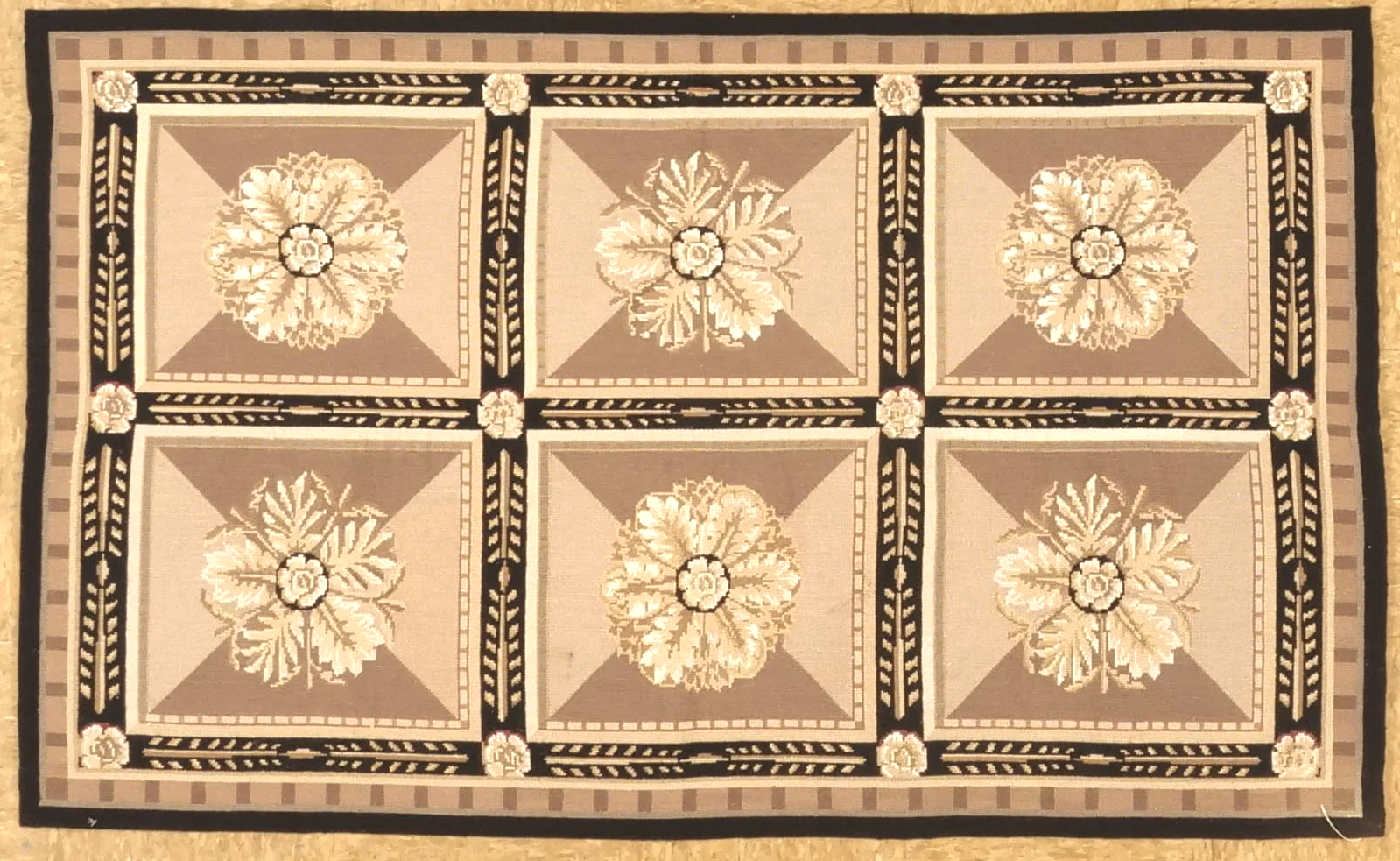 Horizontal image of new handwoven geometric needlepoint carpet