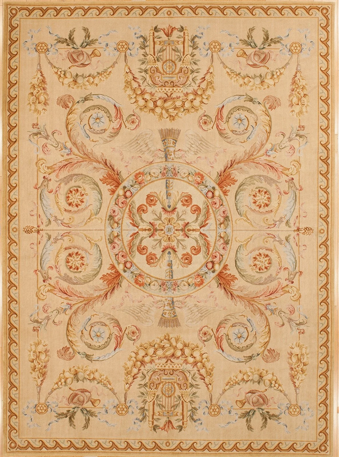 A Savonnerie rug with floral and musical motifs in pastel colors including beige, pink, green, and blue, featuring symmetrical patterns and a border with a wavy design.