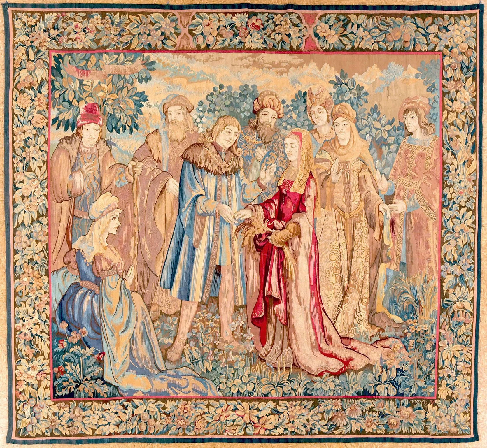 A tapestry depicting a historical or biblical scene with a group of people gathered outdoors, surrounding a central figure in a red robe. The scene includes men and women with various postures and expressions, set against a lush, floral background.